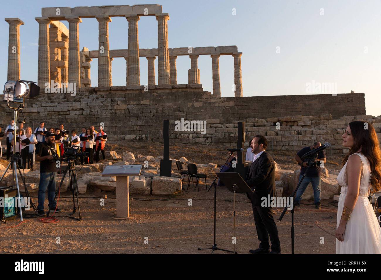 200917 -- ATHENS, Sept. 17, 2020 -- Singers perform a musical in front of the ruins of the Temple of Poseidon at cape Sounion, some 70 km southeast of Athens, Greece, on Sept. 17, 2020. On the occasion of the 70th anniversary of the establishment of the Greek National Tourism Organization GNTO and the 71st anniversary of the founding of the People s Republic of China and the Mid-Autumn festival, a musical entitled As long as there shall be Achaeans -- Variations on a Sunbeam was staged on Thursday in front of the ruins of the emblematic 2,500-year-old Temple of Poseidon, the god of the sea in Stock Photo