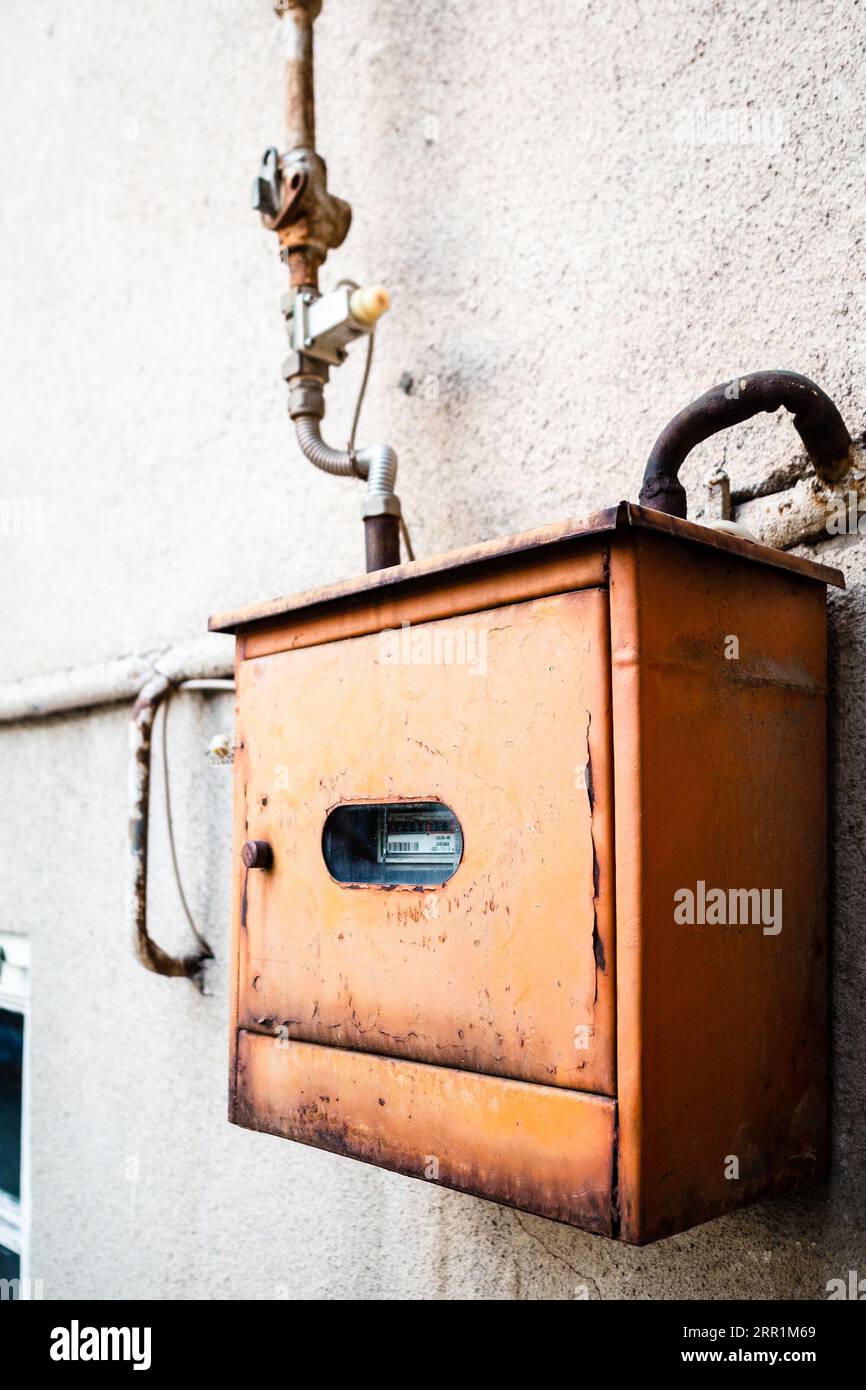 gas meter in old iron box on outdoor wall of city house closeup in Yerevan, Armenia Stock Photo