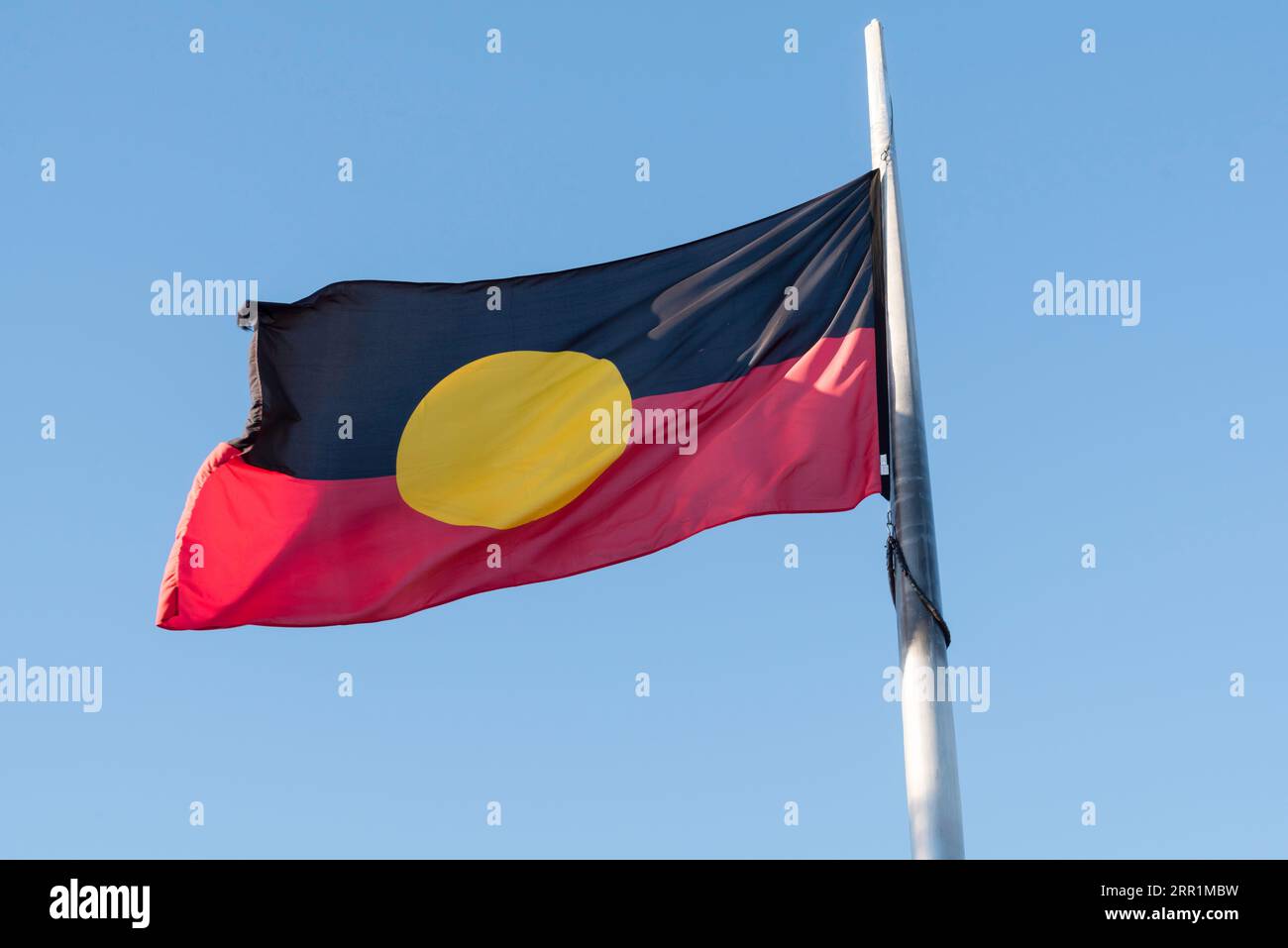 The Australian Aboriginal Flag is the officially designated and legislated flag of the Australian Aboriginal (First Nations) indigenous people. Stock Photo