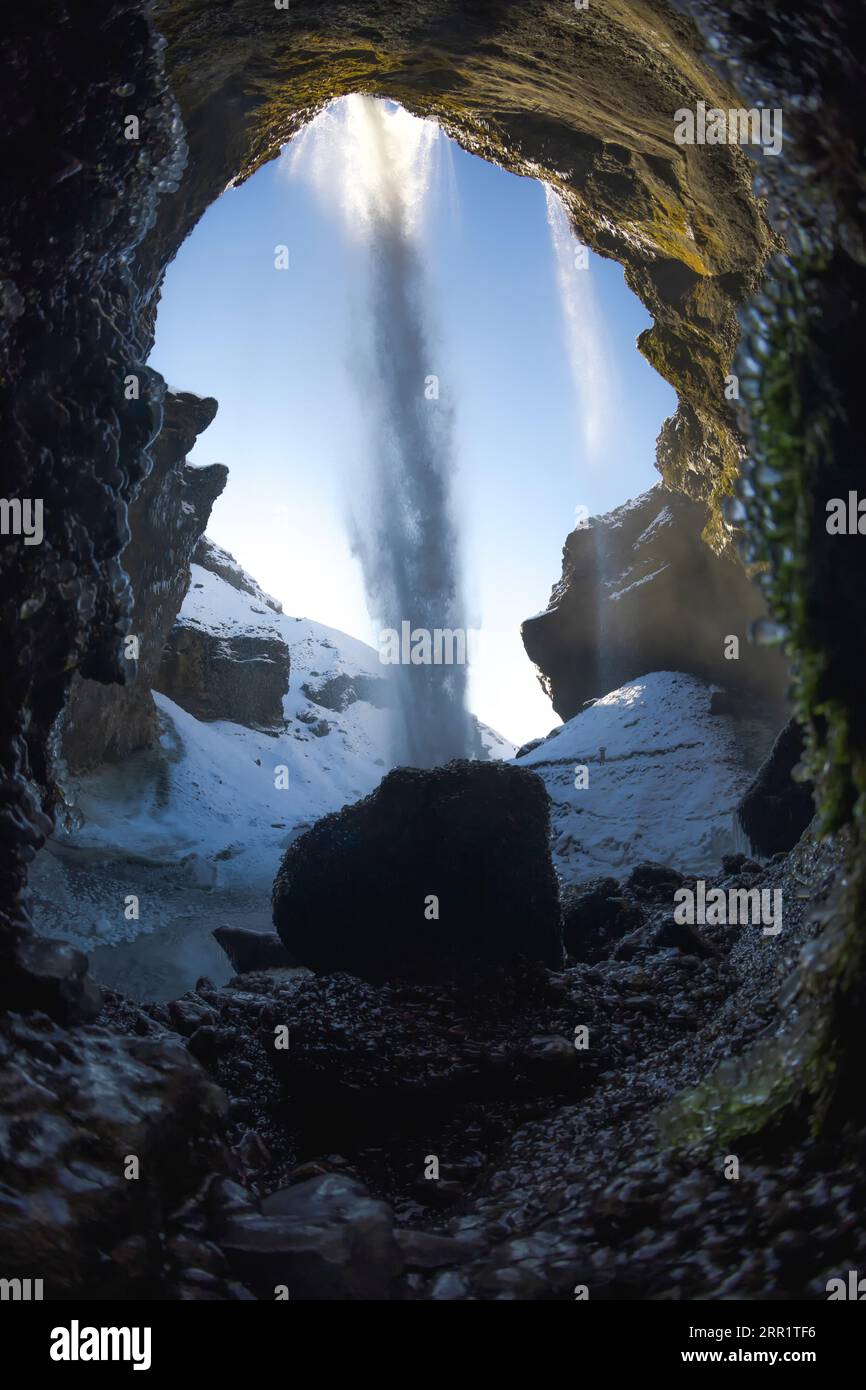 Picturesque scenery of striking view of waterfall from behind of ...