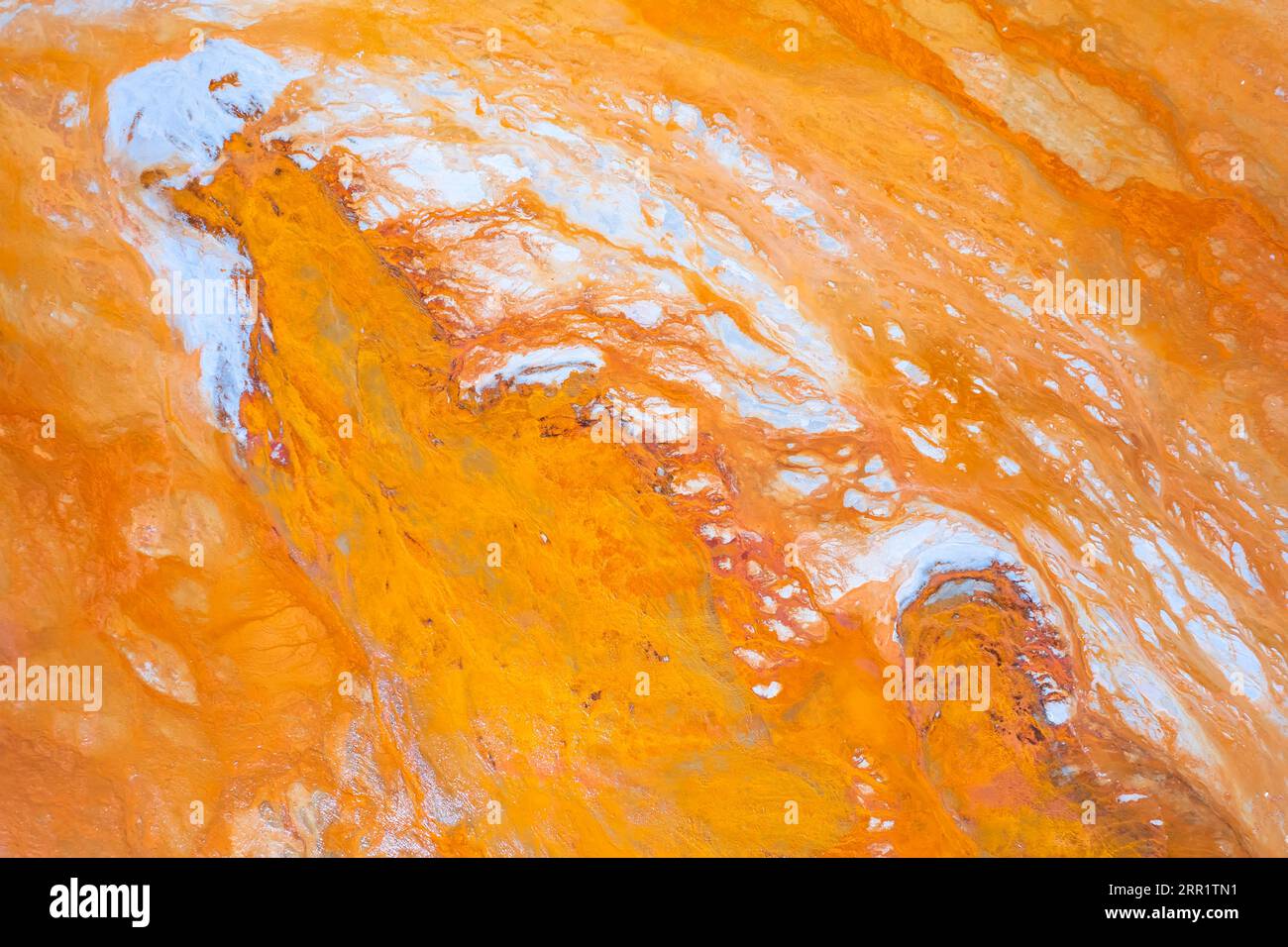 Top view of abstract background with bright yellow rough surface and blue colored granular micro mineral formations on marble stone in light Stock Photo