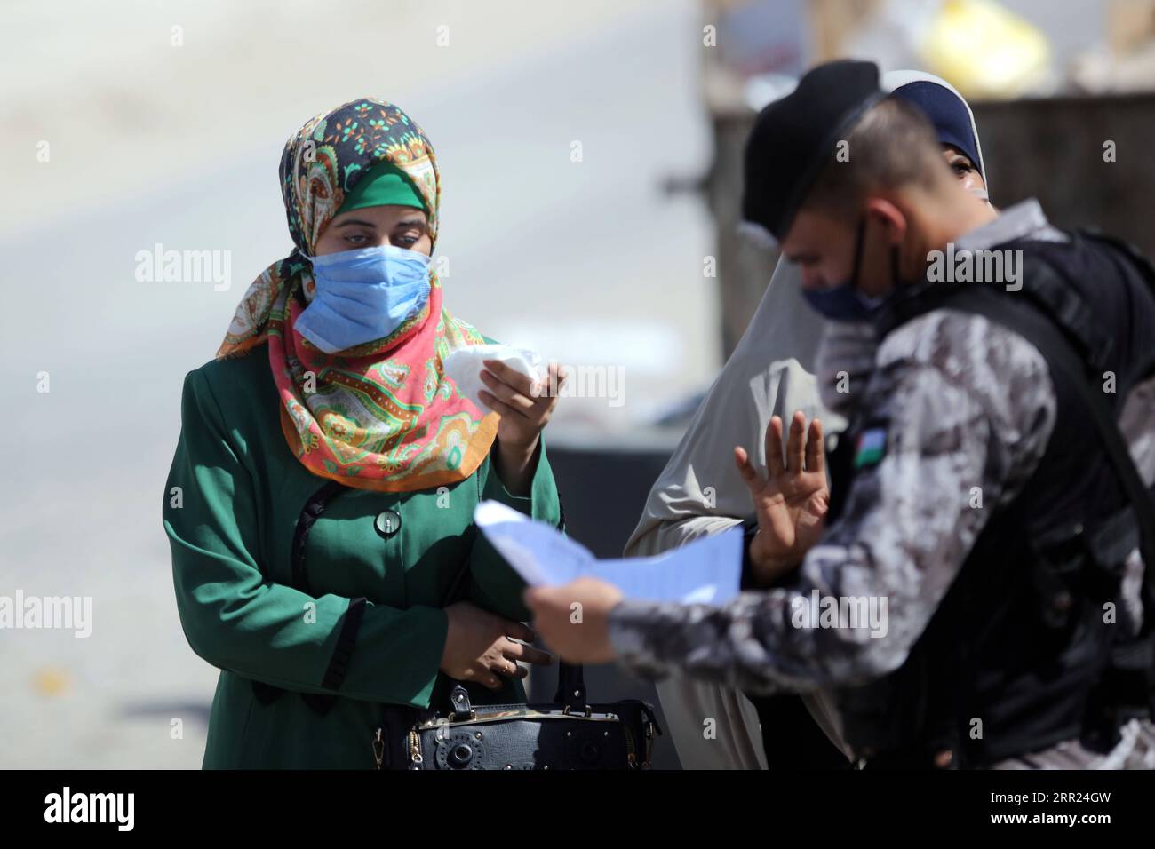 201001 -- AMMAN, Oct. 1, 2020 -- Pedestrians wearing face masks are checked at a checkpoint during a lockdown in Baqa a Palestinian refugee camp in Amman, Jordan, on Oct. 1, 2020. Jordanian Health Ministry reported 1,276 new coronavirus cases on Thursday, raising the total infections in Jordan to 13,101, including 69 deaths and 4,752 recoveries. Photo by /Xinhua JORDAN-AMMAN-COVID-19-CASES MohammadxAbuxGhosh PUBLICATIONxNOTxINxCHN Stock Photo