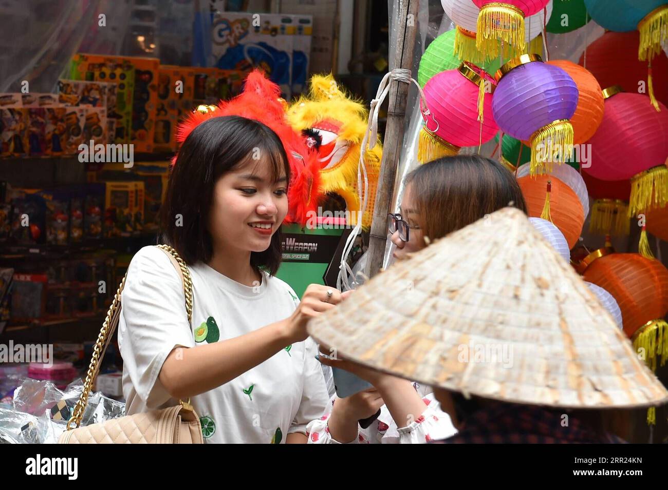 201002 -- HANOI, Oct. 2, 2020 -- People select products at a store in an ancient block in Hanoi, Vietnam, Oct. 1, 2020. A traditional Vietnamese Mid-Autumn Festival, celebrated on the eighth lunar month s full moon night, involves the customs of moon contemplating, procession of star and moon-shaped lanterns, lion dance, as well as holding parties with moon cakes and fruits amid the cool weather of autumn. Parents were busy during the harvest, so the holiday after that was a chance to spend time with their children. Over the years, it had been widely recognized as a festive event for kids acro Stock Photo