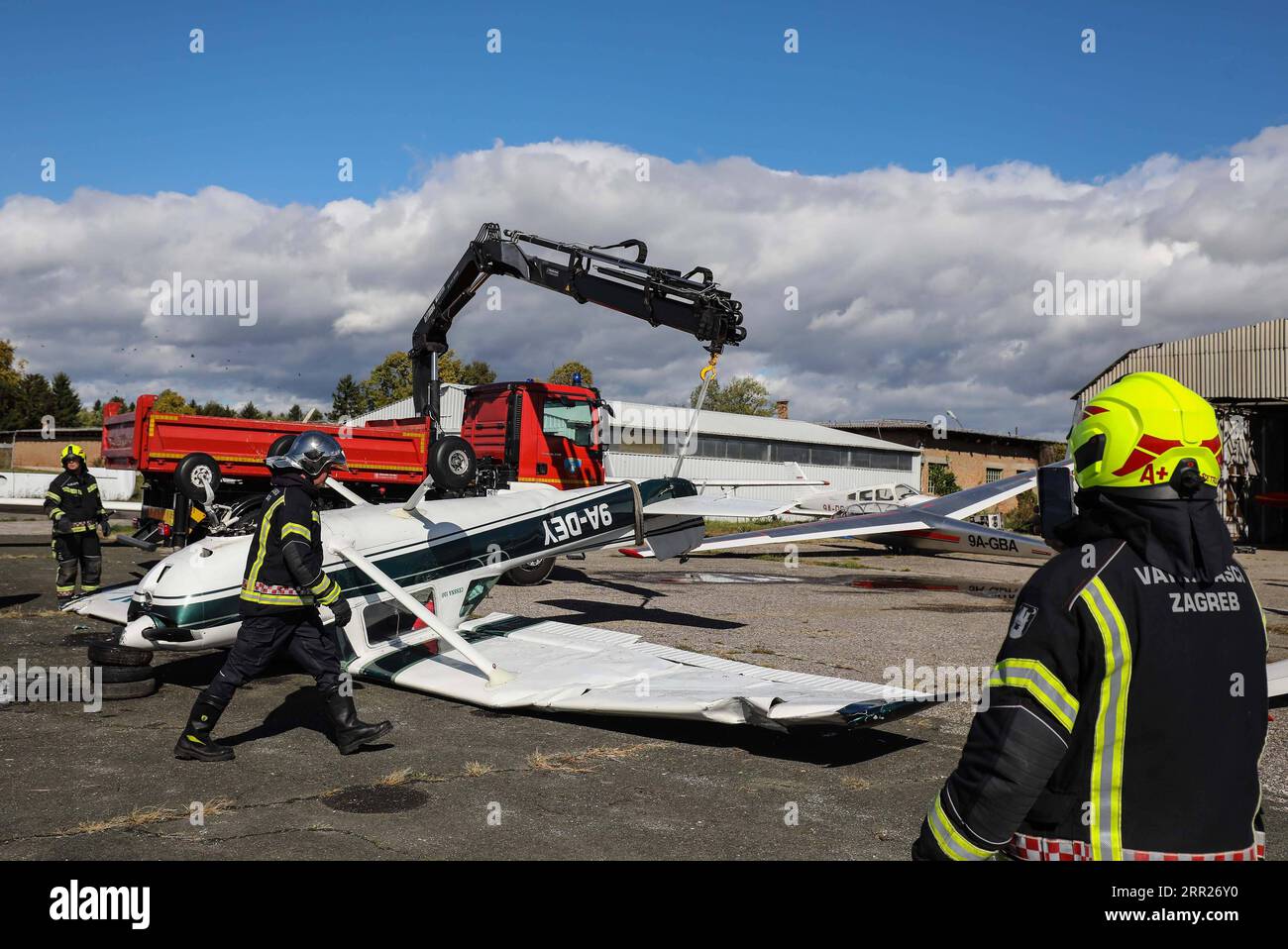 201004 -- ZAGREB, Oct. 4, 2020 -- Firefighters prepare to turn over a plane damaged by strong wind at Lucko Sport Airport near Zagreb, Croatia, Oct. 4, 2020. A big storm with strong wind, heavy rain and hail hit northwestern Croatia on Saturday night. /Pixsell via Xinhua CROATIA-ZAGREB-STORM-AIRPORT JuricaxGaloic PUBLICATIONxNOTxINxCHN Stock Photo