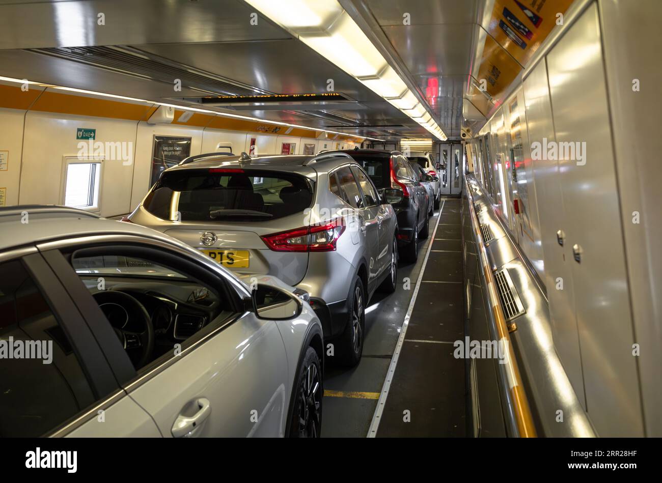 Passengers cars loaded onto the Eurotunnel train known as Le Shuttle using the Channel Tunnel from Folkestone in the UK to Calais in France. Stock Photo