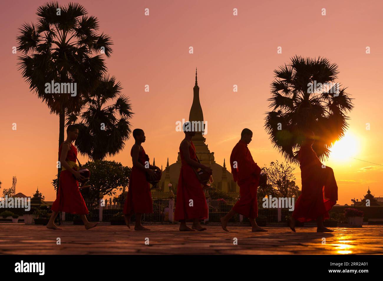 201007 -- VIENTIANE, Oct. 7, 2020 -- Monks pass by That Luang Stupa in Vientiane, Laos, on Oct. 26, 2019. Laos is the only landlocked country in Southeast Asia. In the central part of the country, the capital Vientiane is located on the alluvial plain on the Mekong River, suitable for fishing and plantation. The Lan Xang Kingdom, the first unified multi-ethnic nation in the history of Laos, moved its capital to Vientiane in the mid-16th century, and Vientiane gradually prospered. Photo by /Xinhua CitySketchLAOS-VIENTIANE KaikeoxSaiyasane PUBLICATIONxNOTxINxCHN Stock Photo