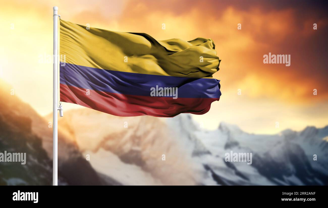 Flag of Colombia on a flagpole against a colorful sky Stock Photo