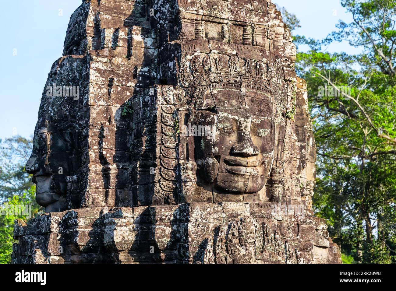 Giant stone faces of ancient Bayon temple. The stone faces of the khmer king on the wall of Bayon Temple, Angkor Thom, Siem Reap, Cambodia. Stock Photo