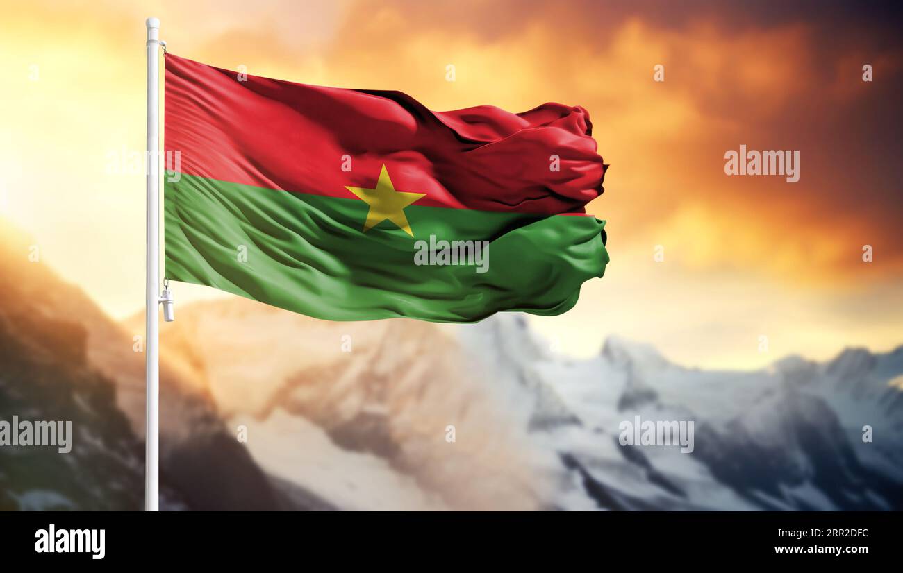 Flag of Burkina Faso on a flagpole against a colorful sky Stock Photo ...