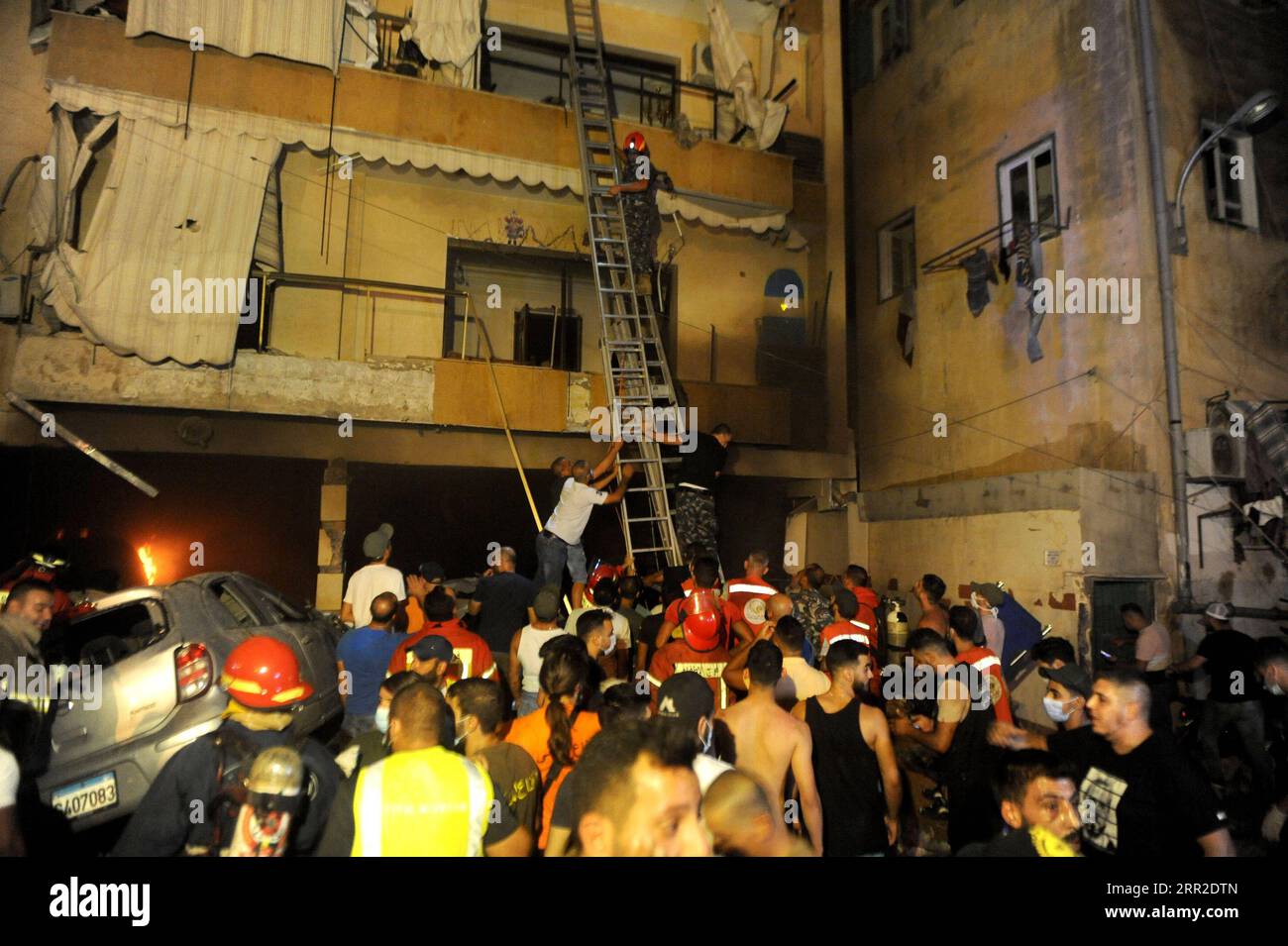 201009 -- BEIRUT, Oct. 9, 2020 -- Civil defense members help people evacuate from a building after a warehouse explosion in Tariq El Jdide neighborhood in Beirut, Lebanon, Oct. 9, 2020. Two people were dead and more than 20 others injured in an explosion at a warehouse in Lebanon s capital Beirut on Friday night, al-Jadeed TV channel reported.  LEBANON-BEIRUT-WAREHOUSE EXPLOSION BilalxJawich PUBLICATIONxNOTxINxCHN Stock Photo