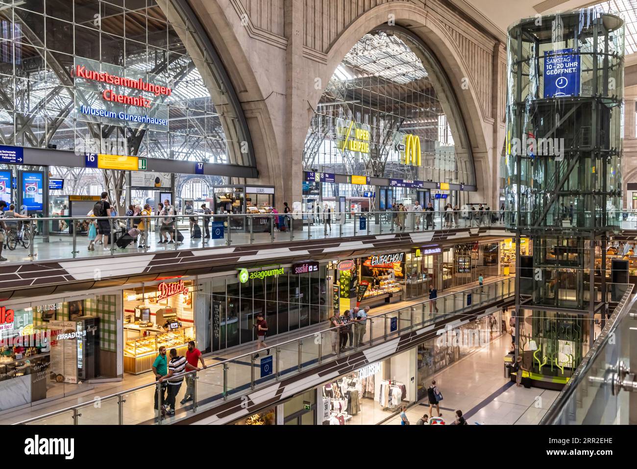Promenades in the station building of Leipzig Central Station. Over 140 shops, restaurants and service providers on three floors fill the interior of Stock Photo