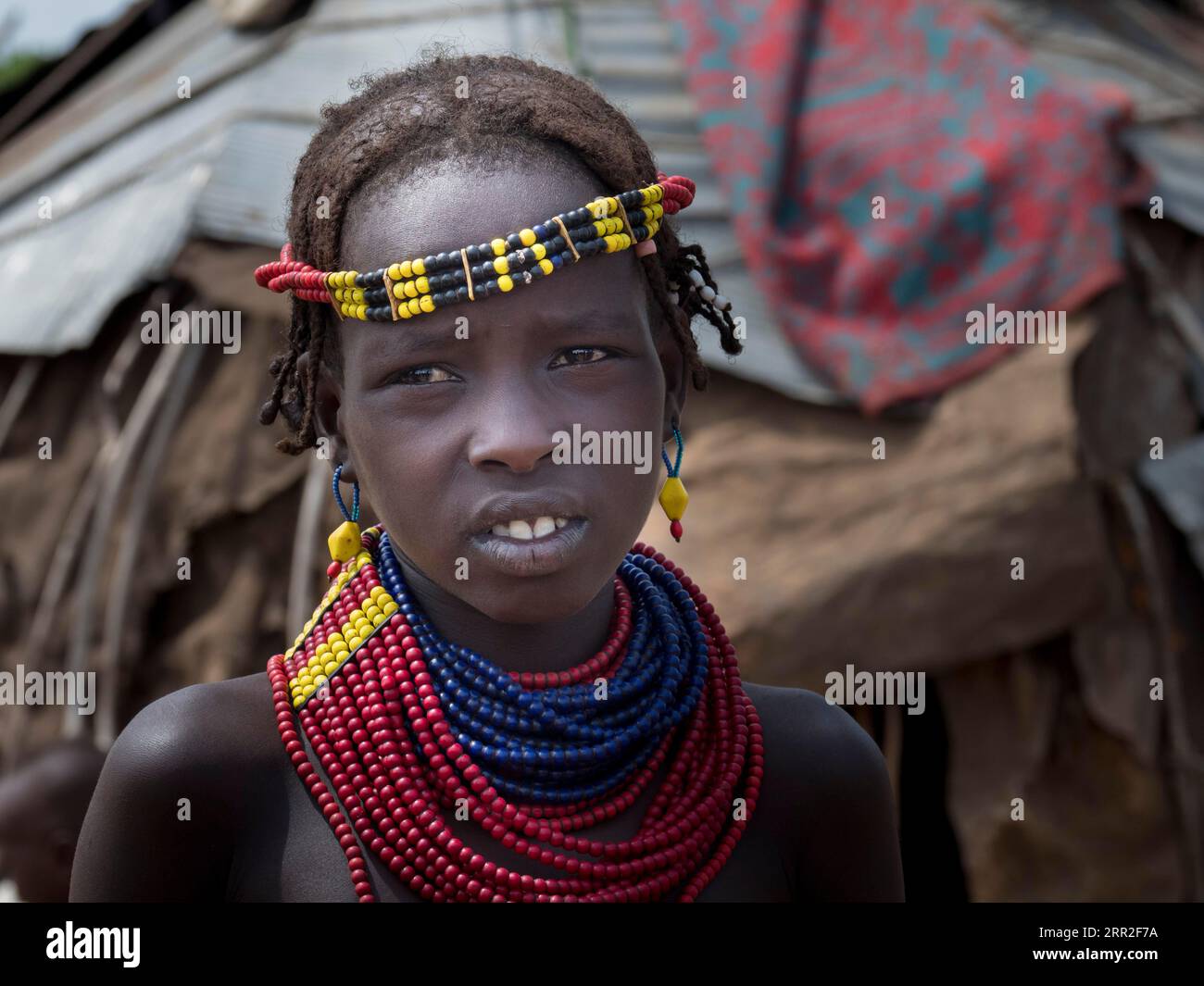 Portrait, girl with neck- and headdress in the village of the Dassanech, Ethiopia Stock Photo