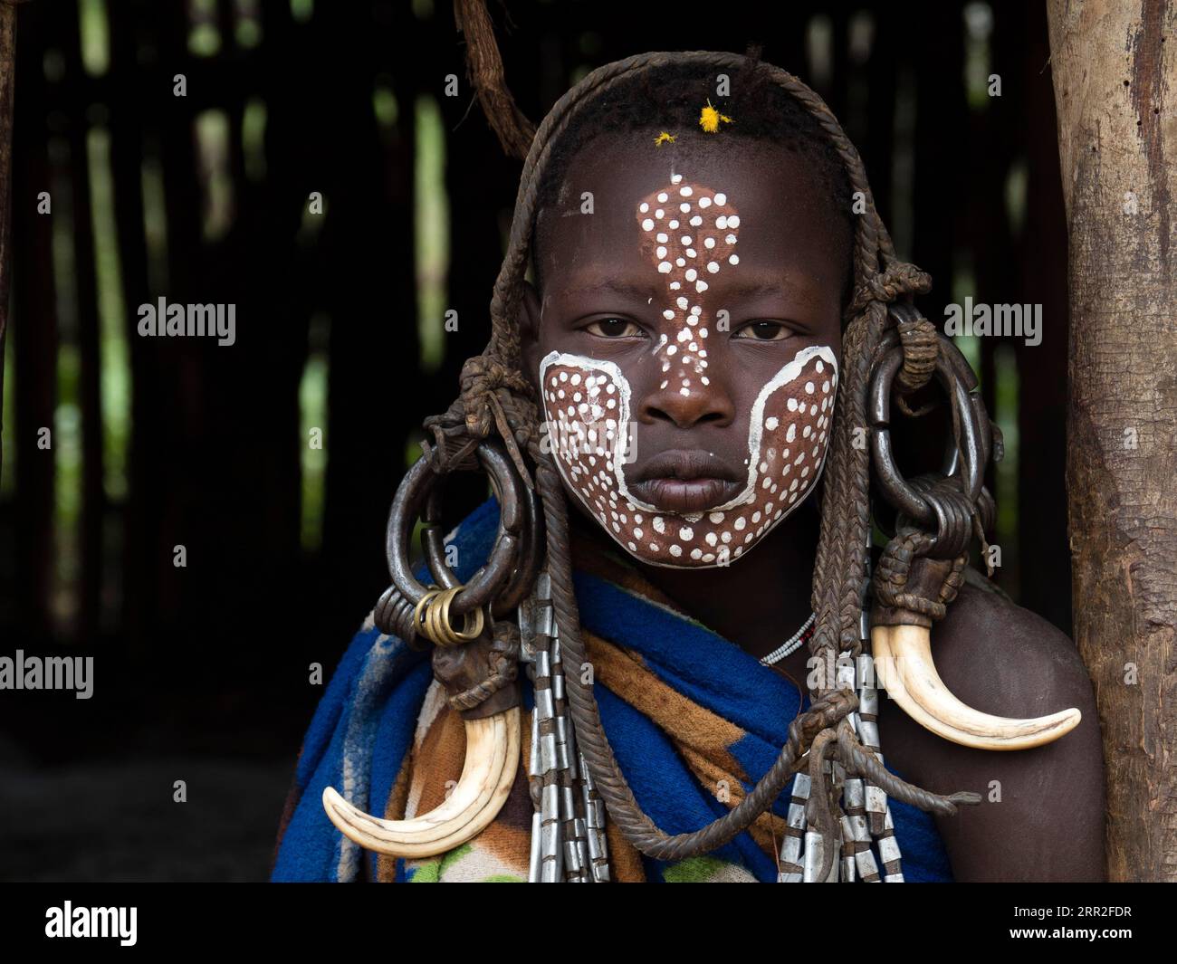 Boy of the Mursi tribe with headdress and face painting, portrait
