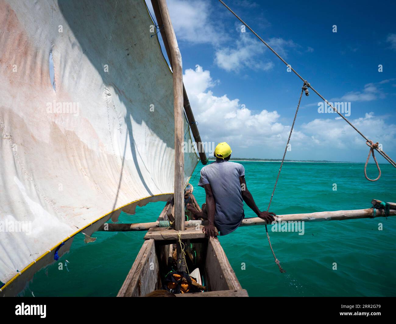 Local on outrigger boat, Ngalawa boat, dhow, Zanzibar, Tanzania Stock Photo