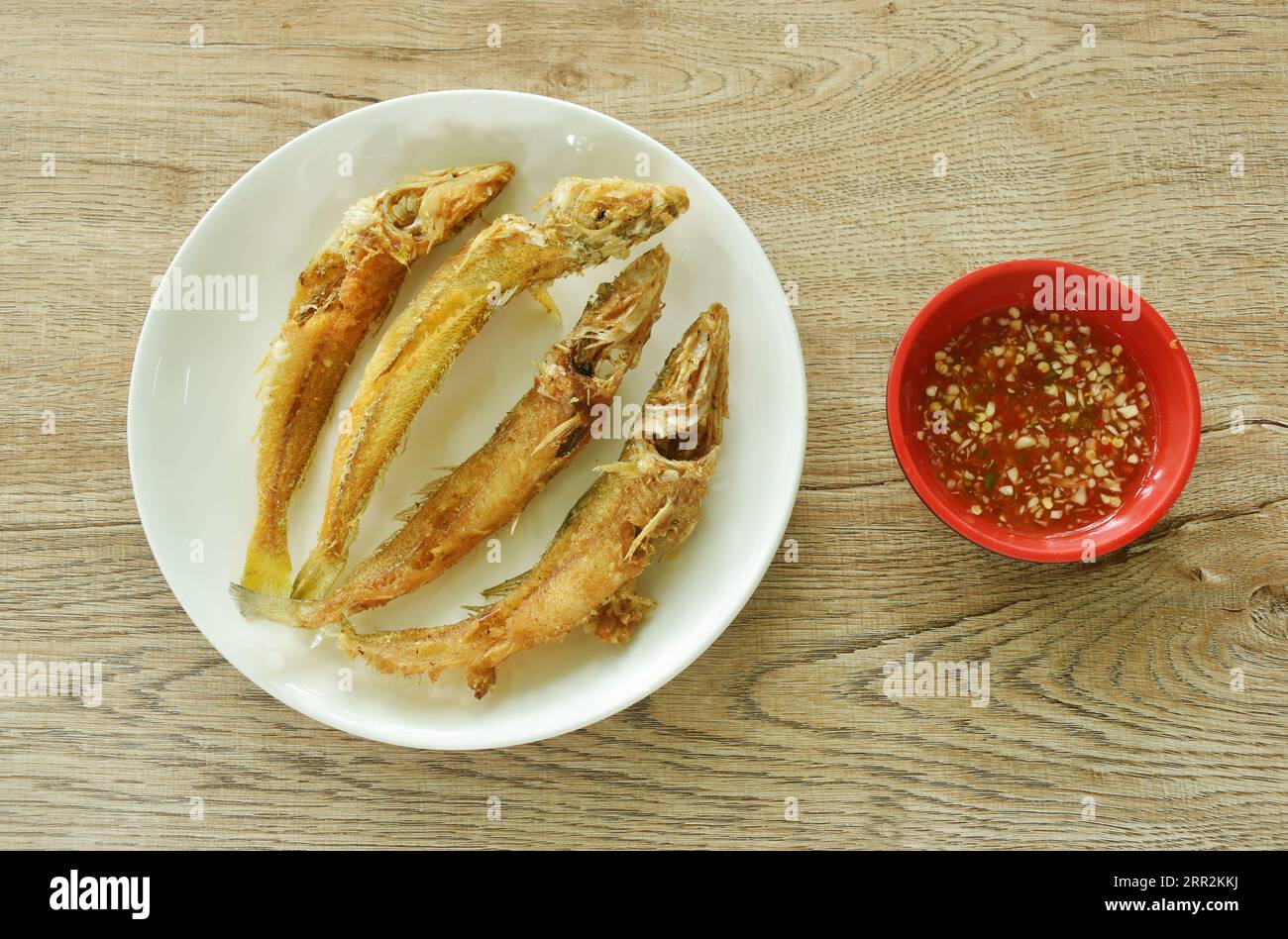 crispy fried sand whiting fish arranging on plate dipping spicy chili sauce in cup Stock Photo
