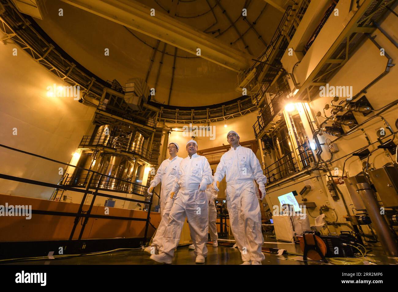 201014 -- SHENZHEN, Oct. 14, 2020 -- Qiao Sukai C and his team leave after finished their work at the Dayawan Nuclear Power Plant in Shenzhen, south China s Guangdong Province, April 12, 2019. Every 18 months, the Dayawan Nuclear Power Plant has to undergo a fuel assemblies replacement, which is one of the most important moments for the nuclear power plant. Dozens of engineers are divided into four shifts and operate the equipment day and night when the reactor is shut down. Their leader, Qiao Sukai, has been dealing with nuclear fuel since July 1993 when the nuclear fuel assembly of Dayawan N Stock Photo