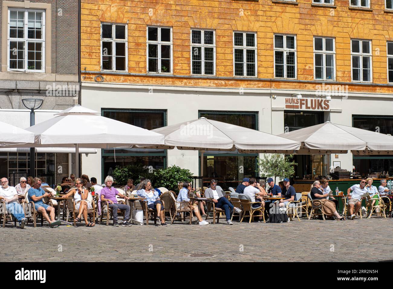 Copenhagen, Denmark, Septmeber 13, 2021: People in outdoor cafes on Gammel Torv Square in the historic city centre on a sunny day Stock Photo