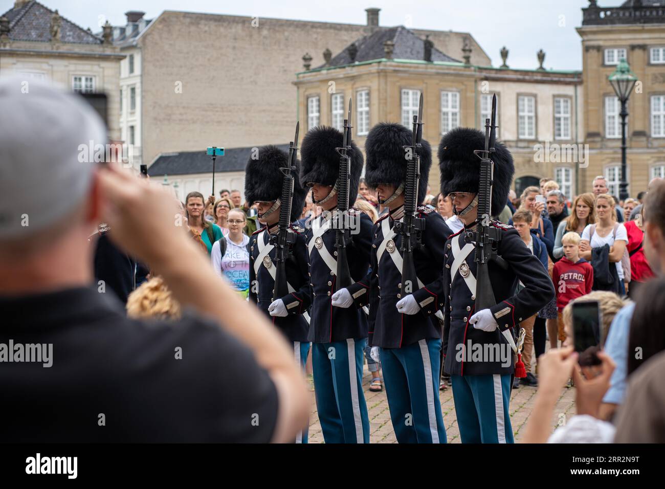 Copenhagen, Denmark, July 18, 2022: People watching group of Danish Royal Guards at Amalienborg Palace for the change of guard ceremony Stock Photo
