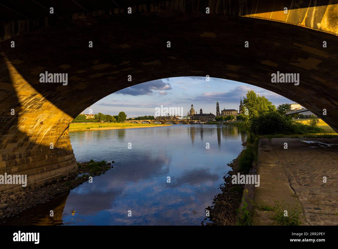 View through the arches of the Marienbruecke onto the Elbe meadows in Dresden's Old Town with silhouette Stock Photo