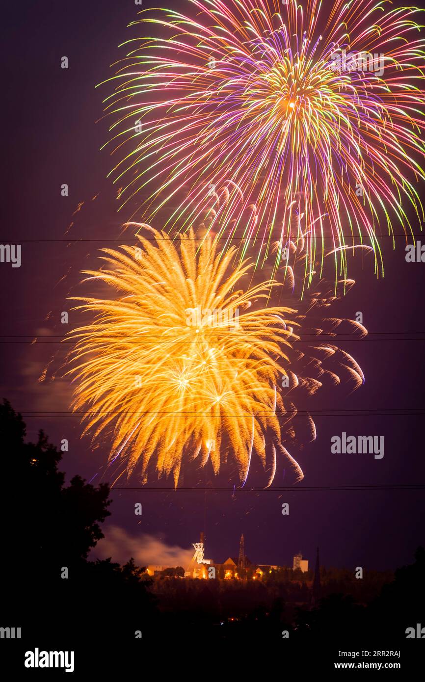 Closing fireworks of the Bergstadtfest at the Reiche Zeche above the towers of Freiberg Stock Photo