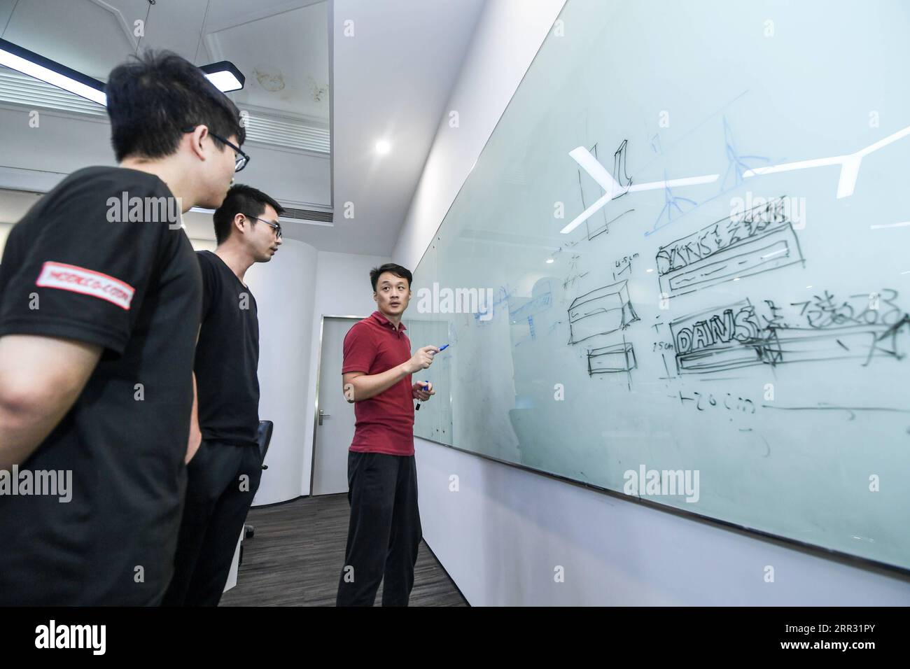201020 -- SHENZHEN, Oct. 20, 2020 -- Animation designers of Shenzhen Dans Digital Technology Ltd. brainstorm at the company in Shenzhen, south China s Guangdong Province, Oct. 16, 2020. Along with 40 years of rapid economic growth, Shenzhen, China s first and most successful special economic zone, has also achieved cultural prosperity. As early as 2003, Shenzhen took the lead in proposing the strategy of making the city culture-nurtured. In 2008, Shenzhen was designated as a UNESCO City of Design, clarifying the transformation of strategic development goal from promoting manufacturing economy Stock Photo