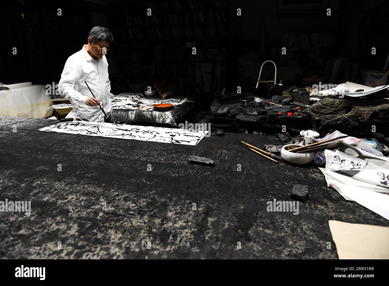 201020 -- SHENZHEN, Oct. 20, 2020 -- Artist Chen Qiuzhi writes Chinese calligraphy in Dafen Village of the Longgang District in Shenzhen, south China s Guangdong Province, Jan. 9, 2019. Along with 40 years of rapid economic growth, Shenzhen, China s first and most successful special economic zone, has also achieved cultural prosperity. As early as 2003, Shenzhen took the lead in proposing the strategy of making the city culture-nurtured. In 2008, Shenzhen was designated as a UNESCO City of Design, clarifying the transformation of strategic development goal from promoting manufacturing economy Stock Photo