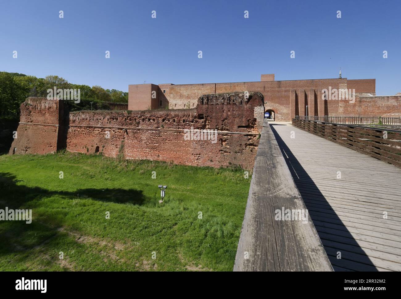 Novara Castle. Wooden bridge and brick castle walls. Novara Castle renovated with new walls and buttresses. Stock Photo