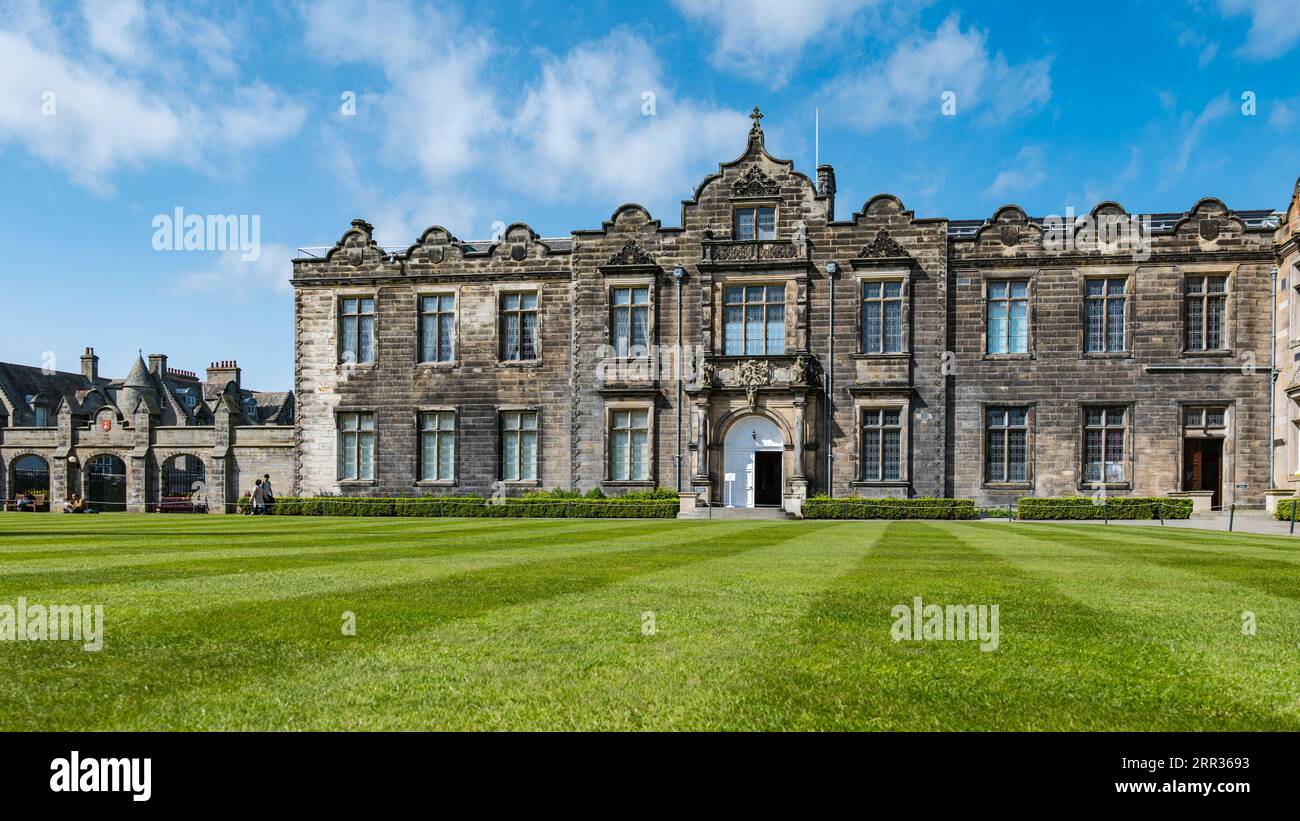 University students relaxing on grass lawn, St Salvator's College Quadrangle, St Andrews University, Fife, Scotland, UK Stock Photo