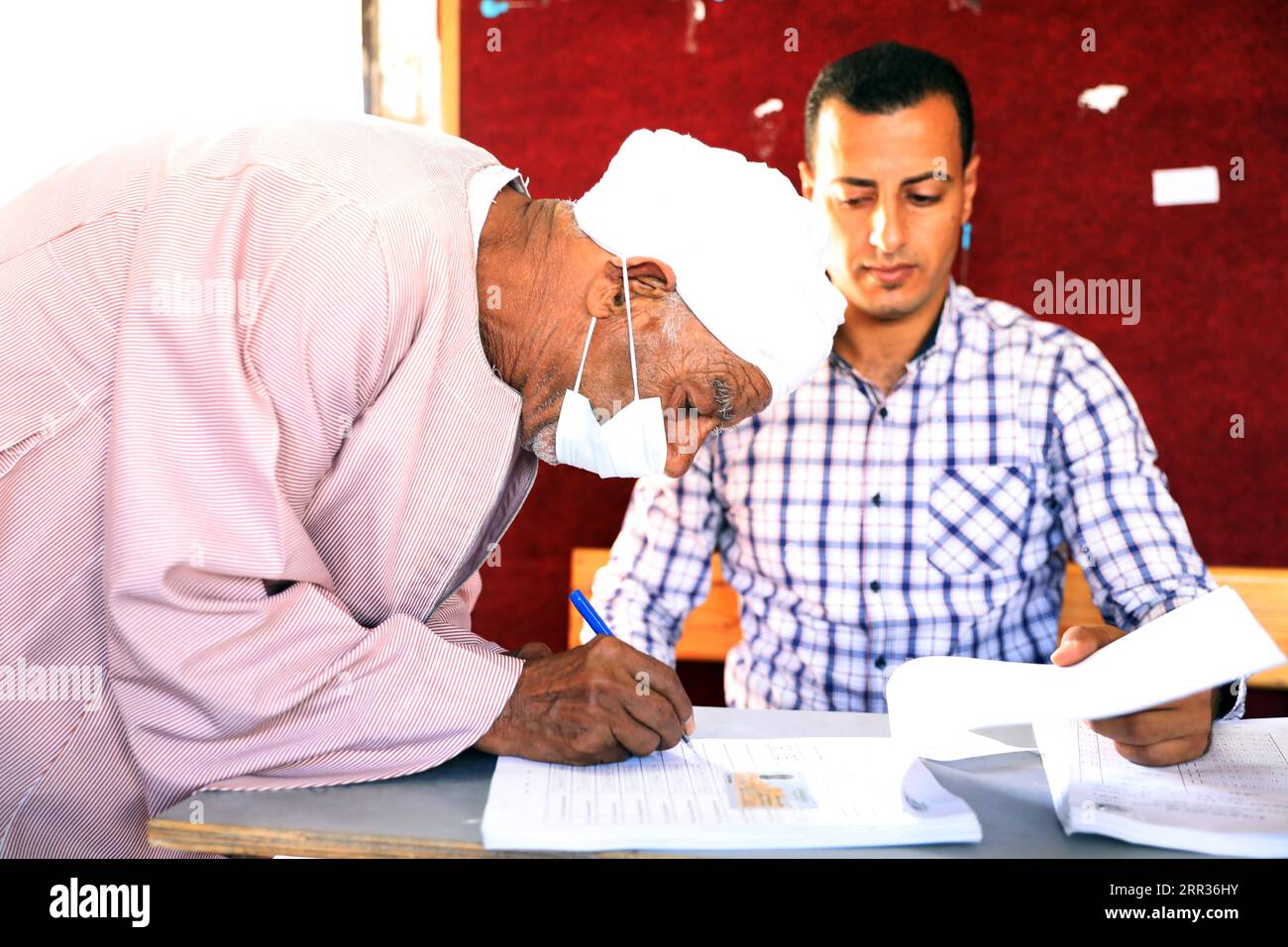 201025 -- HURGHADA, Oct. 25, 2020 -- A man registers for a vote at a polling station in Hurghada, Egypt, on Oct. 24, 2020. The two-day first stage of Egypt s parliamentary elections began on Saturday in 14 provinces including Giza, Alexandria, the Red Sea, Luxor and Aswan, amid tight security measures and precautions against COVID-19 pandemic.  EGYPT-HURGHADA-PARLIAMENTARY ELECTIONS AhmedxGomaa PUBLICATIONxNOTxINxCHN Stock Photo