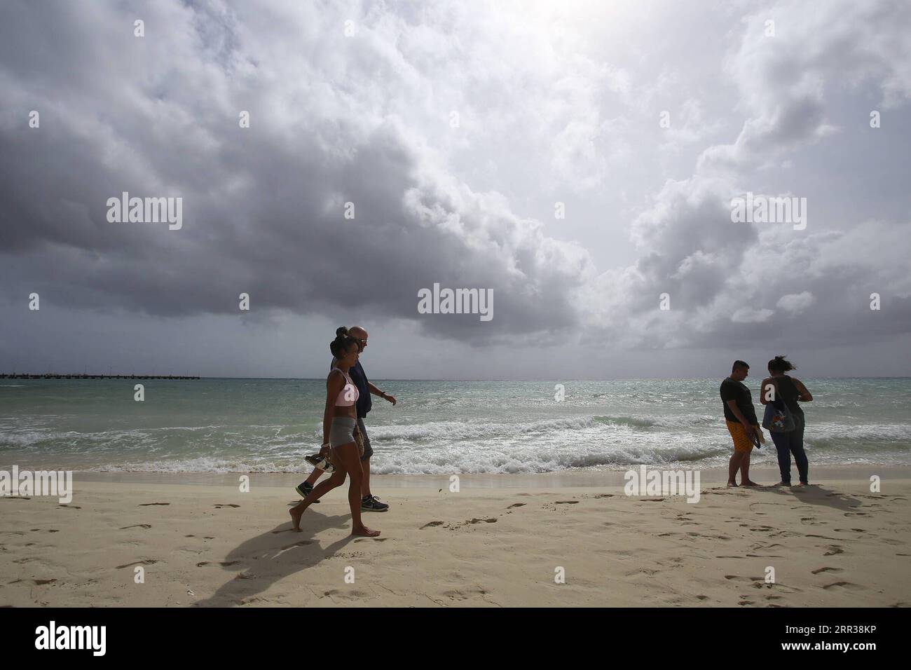 201027 -- QUINTANA ROO, Oct. 27, 2020 -- People walk on the beach as  Hurricane Zeta