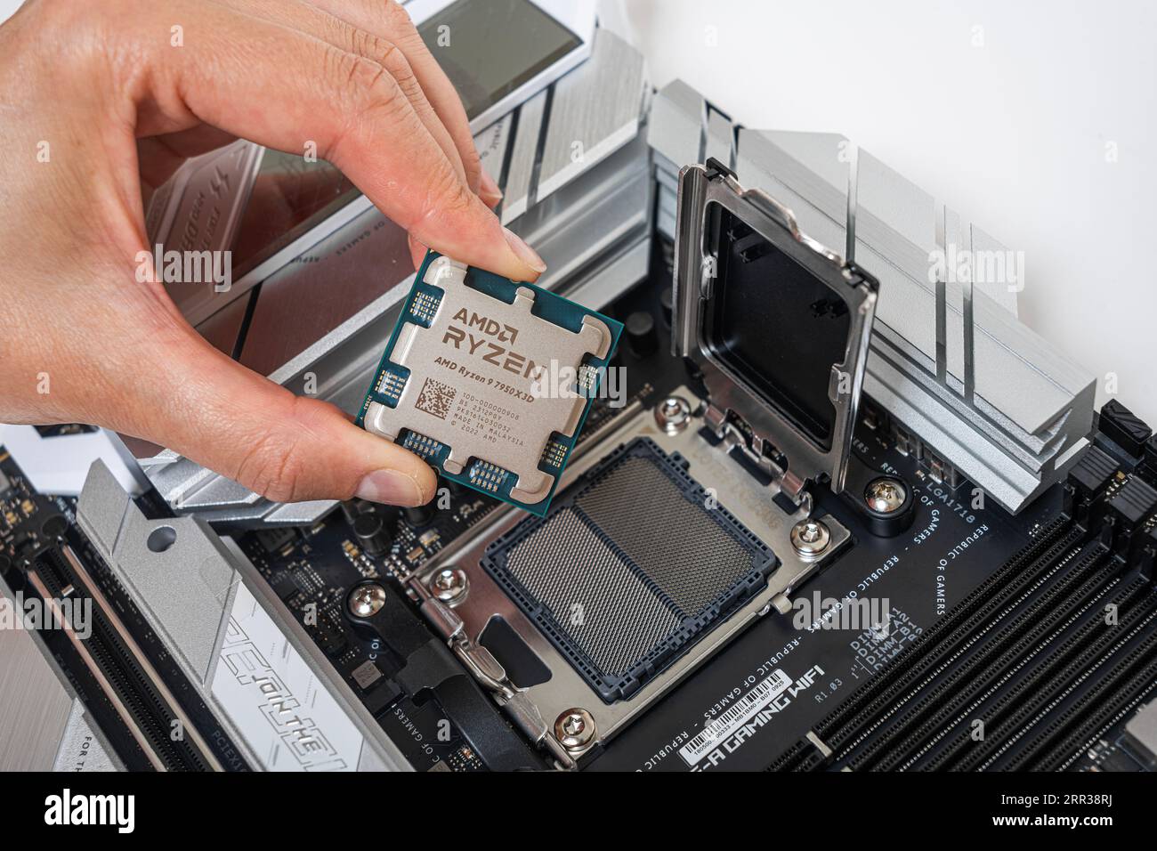 Manual installation of the AMD Ryzen 9 7950X3D processor into the motherboard Stock Photo Alamy