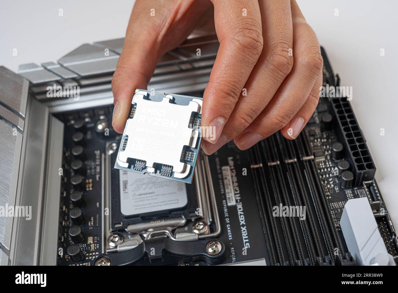 Manual installation of the AMD Ryzen 9 7950X3D processor into the motherboard Stock Photo Alamy