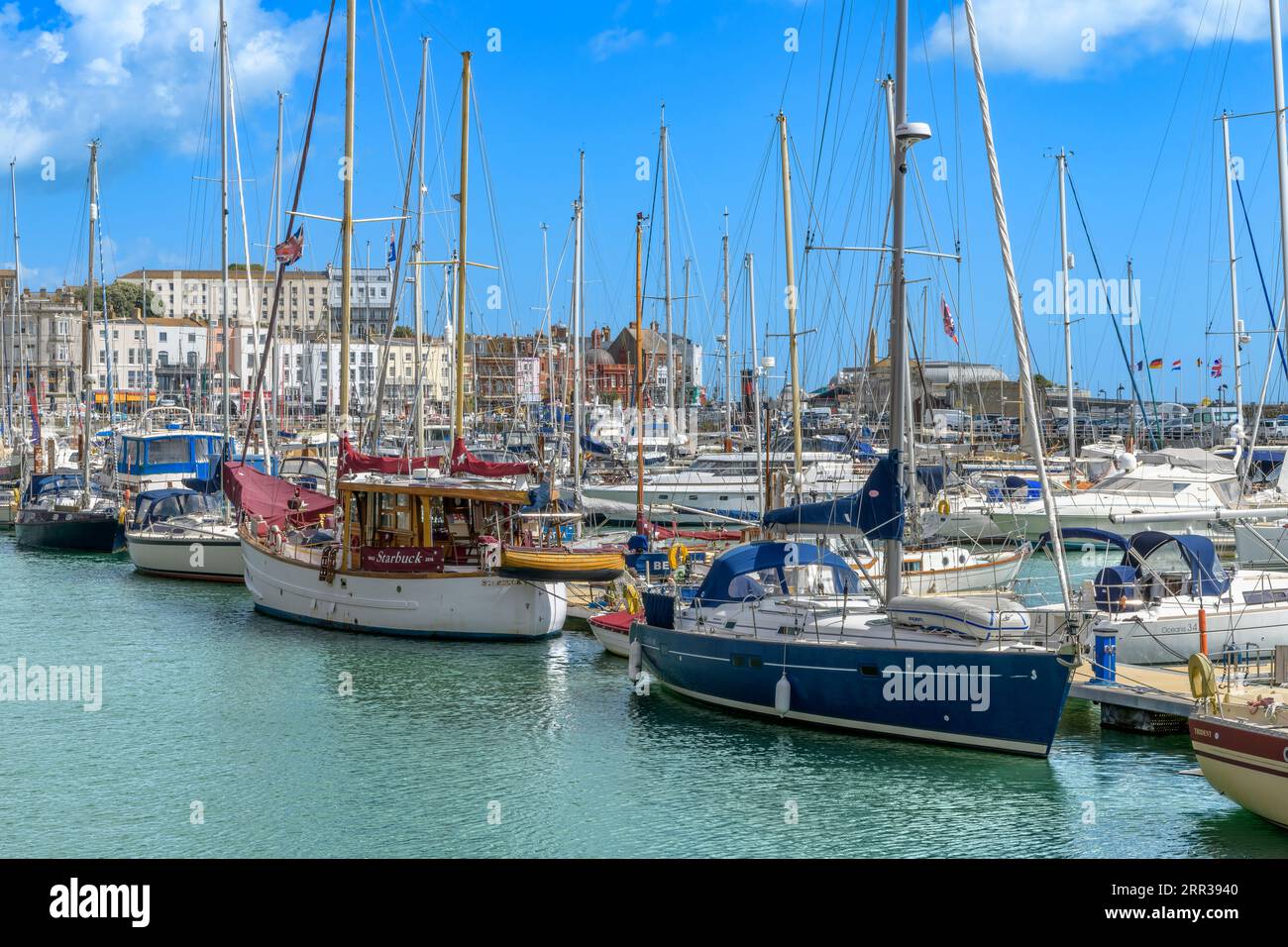 Mid day at Ramsgate Yacht Marina. With fishing boats, yachts, little boats and speed boats. Bright blue skies and reflections on the sea. Stock Photo