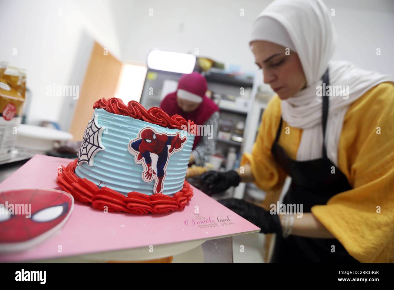 September 5, 2023, Gaza City, The Gaza Strip, Palestine: Palestinian Ayat Mutair, 40 years old, with a hearing disability, defies circumstances and opens her own sweets shop in Gaza City.The young woman, Ayat Mutair (40 years old), who lives in the town of Beit Lahia in the northern Gaza Strip, succeeded in transforming her home sweets-making project into a store specializing in selling various types of sweets.Mutair is a hearing-impaired woman who lost her sense of hearing when she was four years old. This prompted her to develop herself and her talent that she discovered with every dish sh Stock Photo