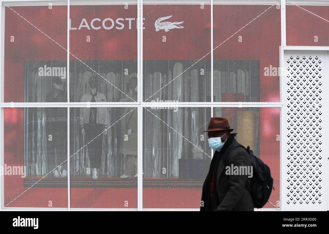 201030 -- PARIS, Oct. 30, 2020 -- A man walks past a closed boutique at the Champs-Elysees Avenue in Paris, France, Oct. 30, 2020. France registered 47,637 cases of coronavirus infection in the past 24 hours, bringing the accumulative total to over 1.28 million on the eve of a national lockdown to stem the brutal second wave of the epidemic, according to official figures released on Thursday. Starting from Thursday midnight, the country s 67 million inhabitants will be locked down until at least early December. People are allowed to go out for work if they cannot do their job at home, to buy e Stock Photo