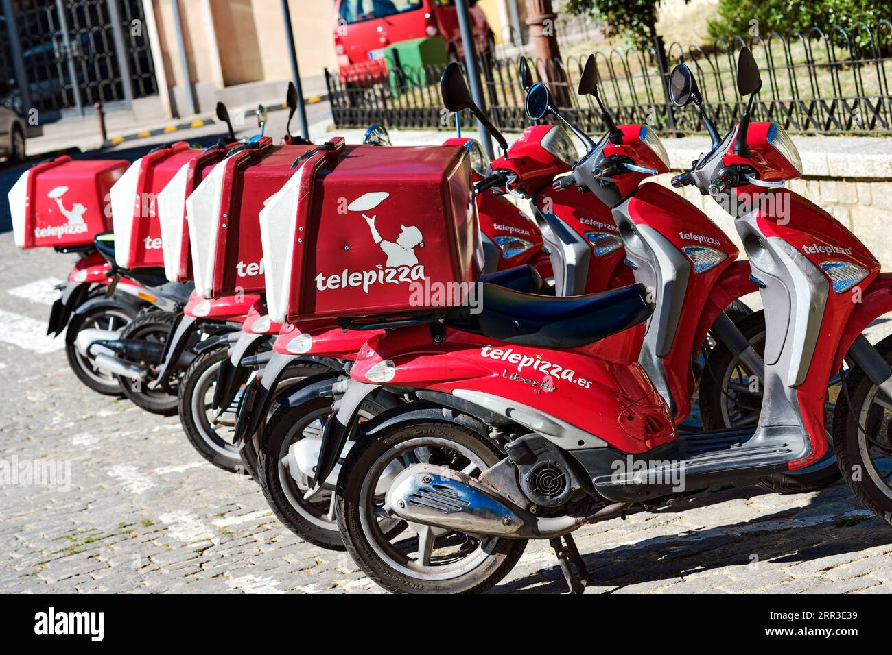 Segovia, Spain - June 28, 2021: Delivery motorbikes of Telepizza, a Spanish multinational pizzeria chain with a presence in several countries around t Stock Photo