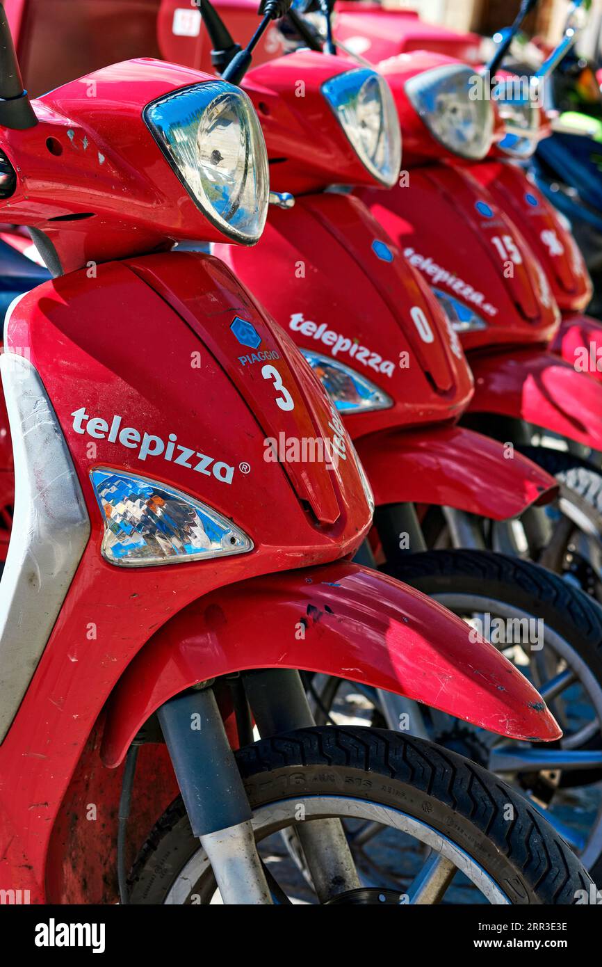 Segovia, Spain - June 28, 2021: Delivery motorbikes of Telepizza, a Spanish multinational pizzeria chain with a presence in several countries around t Stock Photo