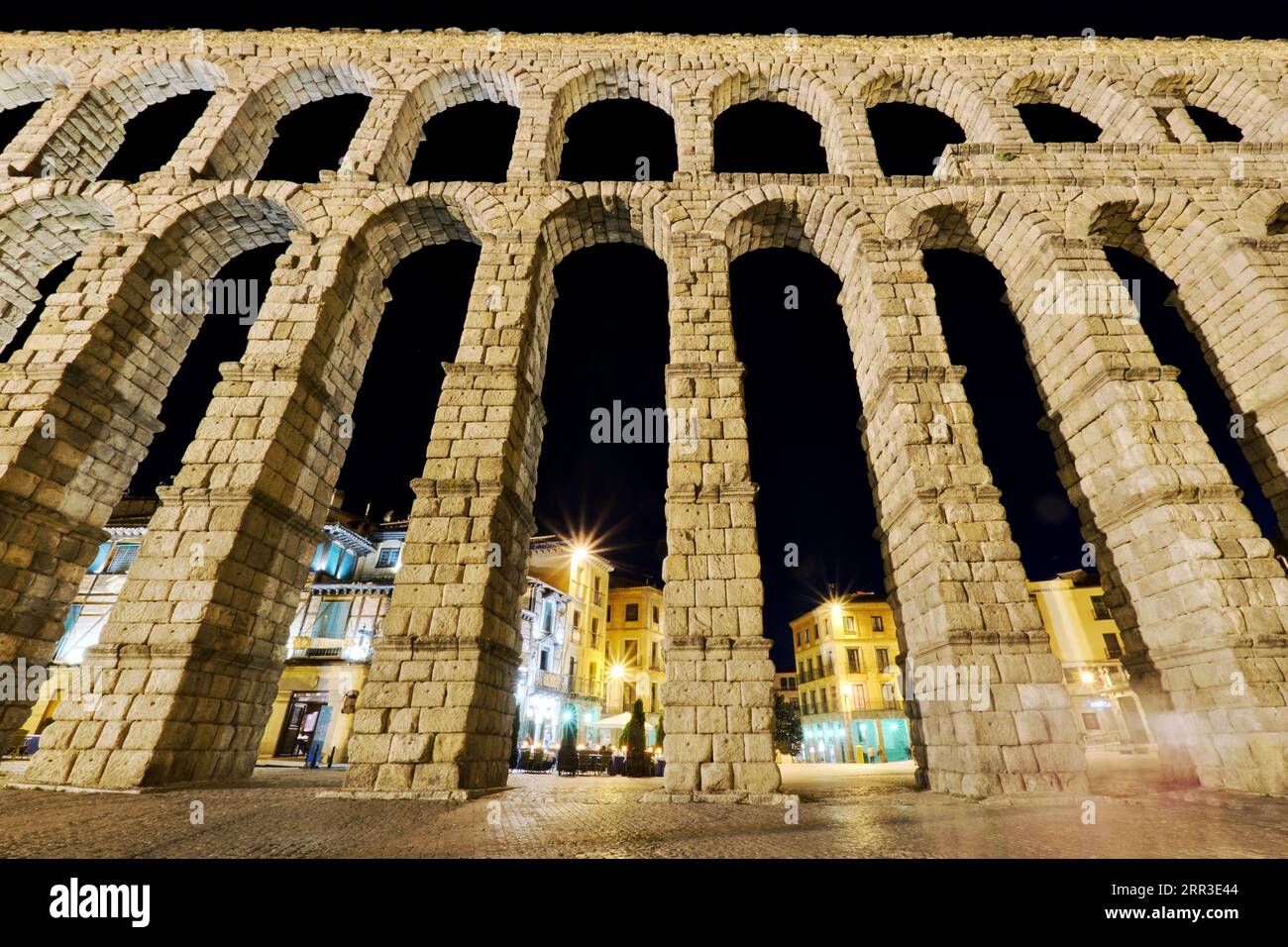 Night view of Segovia cityscape and medieval ancient Roman Aqueduct on ...