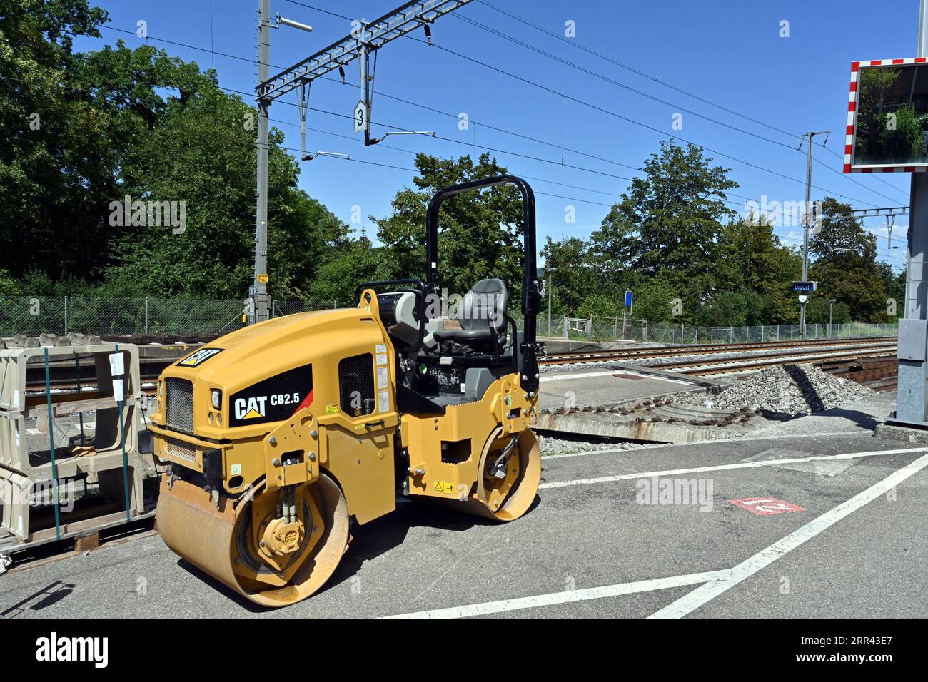 Small yellow tandem vibratory rollers from Caterpillar company  used during reconstruction of railway station in Urdorf, Switzerland. Stock Photo