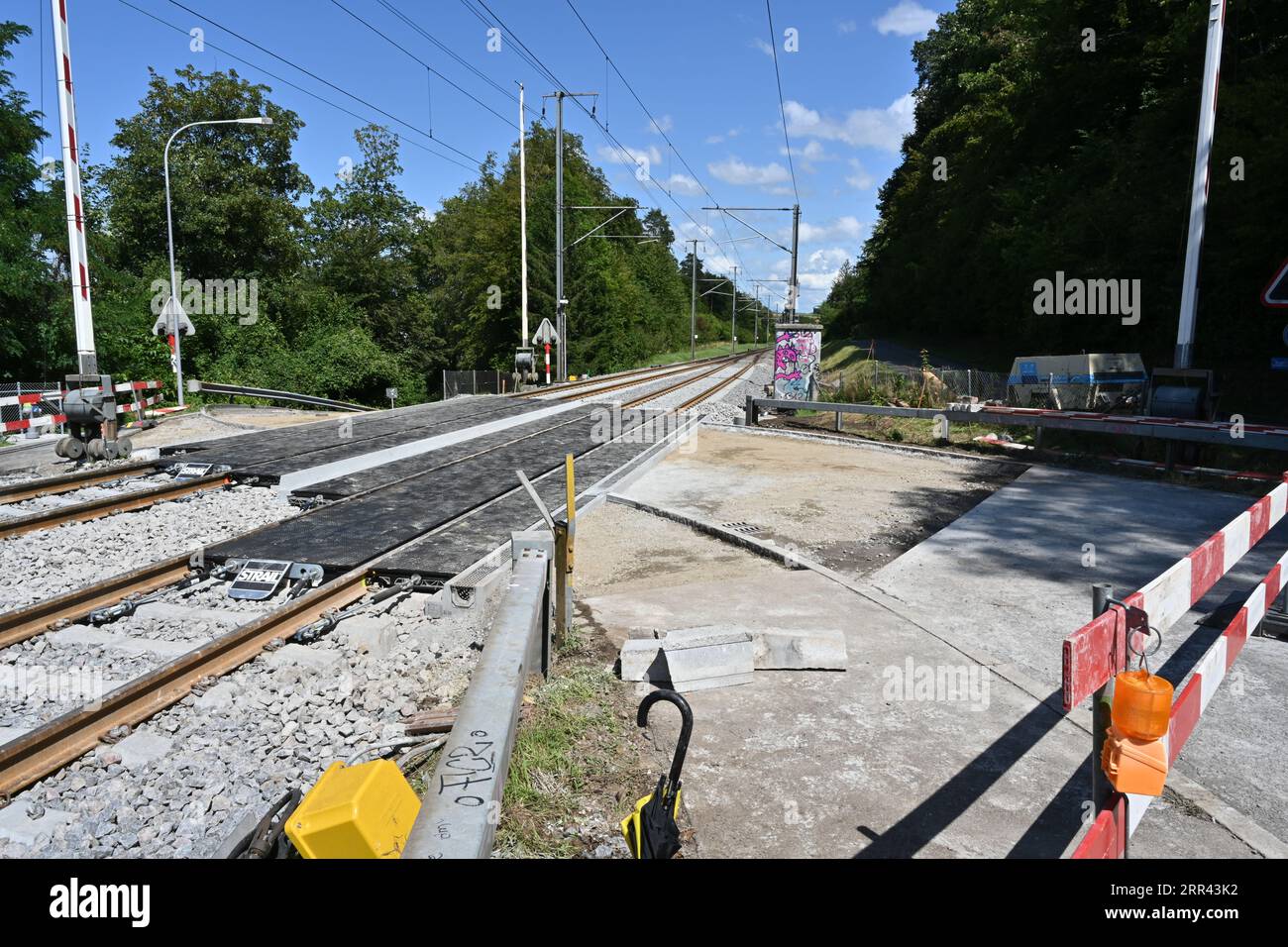 The tracks or rails and new railway crossing under construction leading to the railway station in village Urdorf in Switzerland. Stock Photo