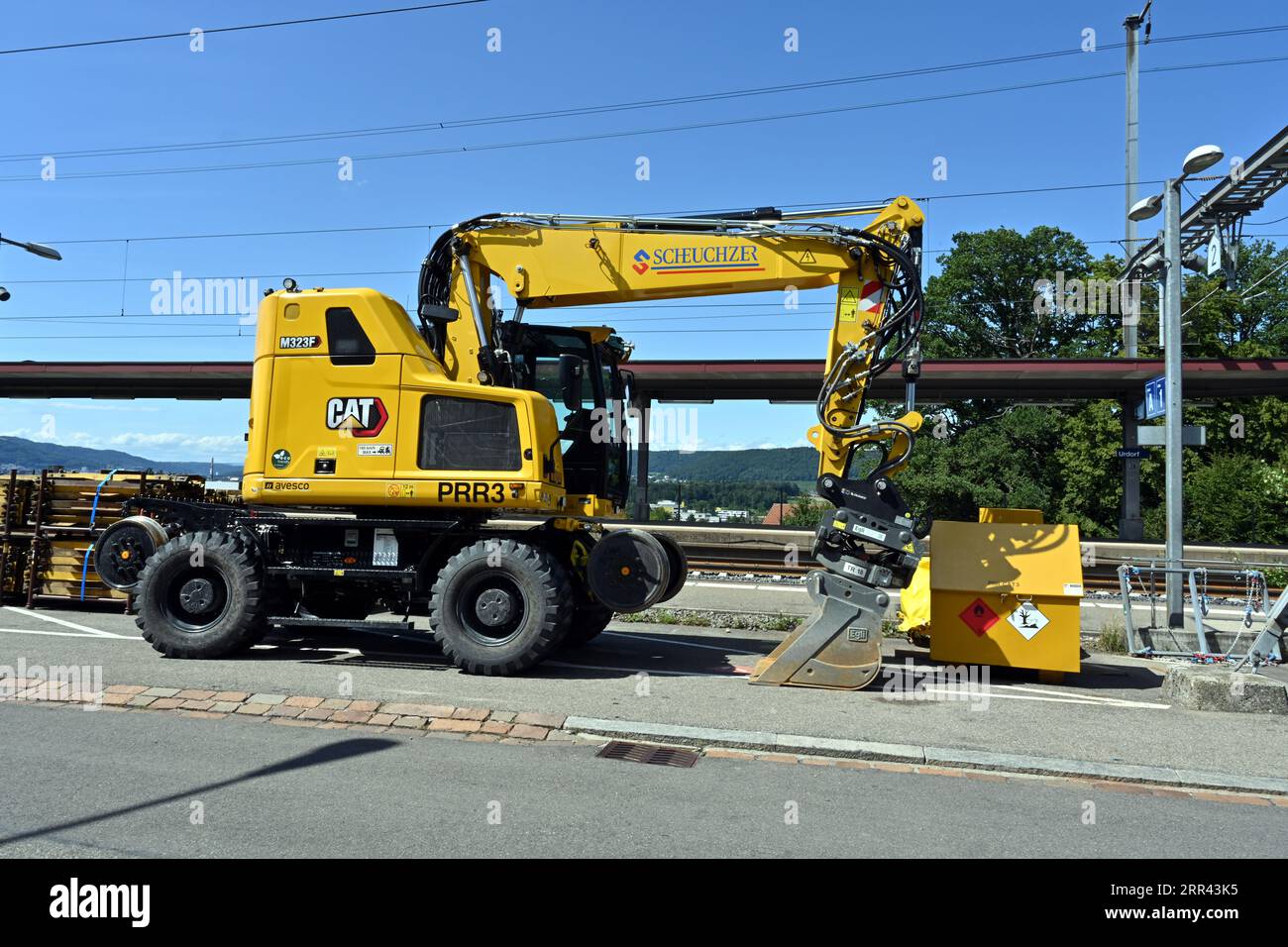 Road-Rail Excavator which offers the ability to easily switch from road to rail situated near construction site. Stock Photo