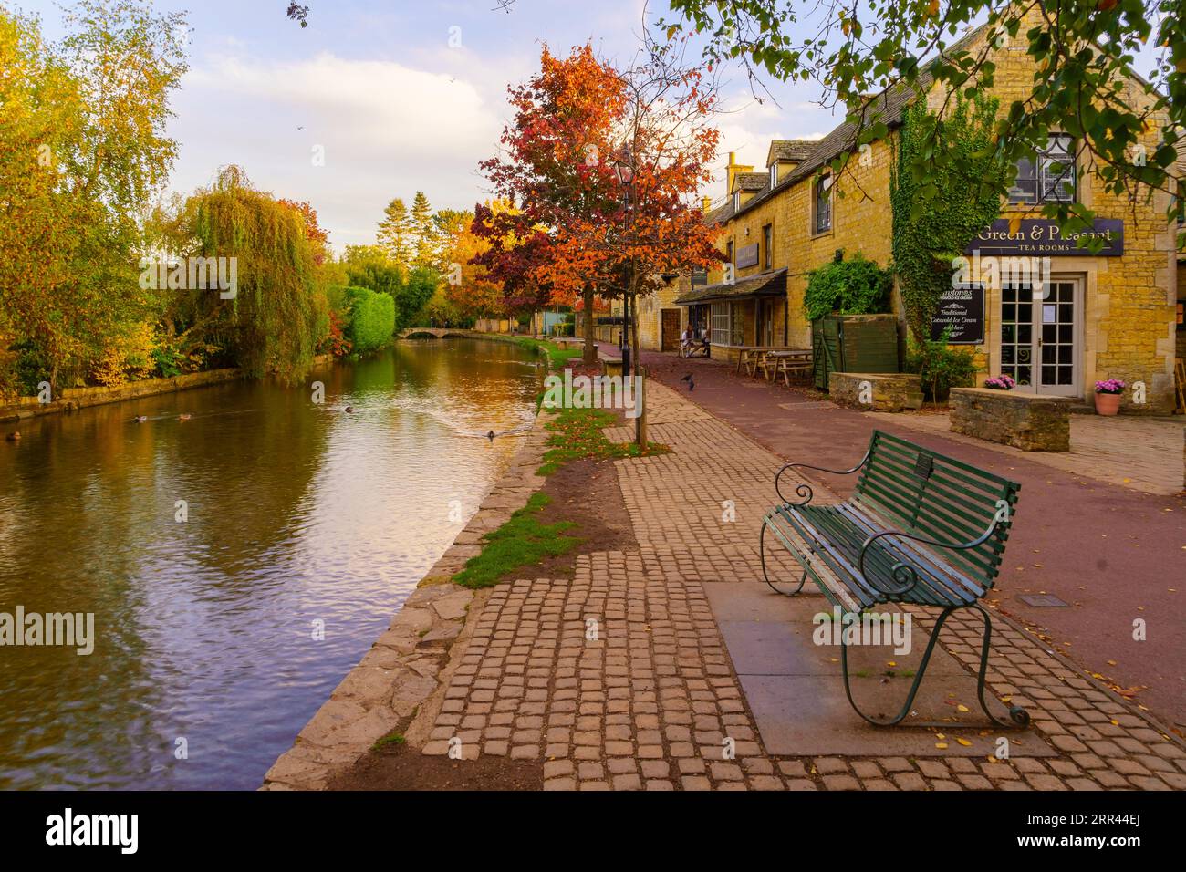 BourtonontheWater, UK October 17, 2022 Sunset scene of typical houses, the river Windrush