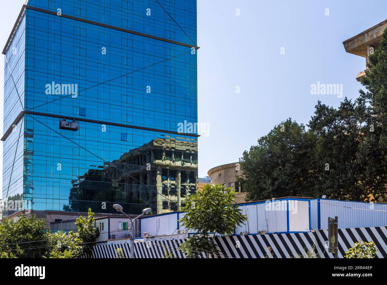 Building in Tbilisi with reflection in the glass facade. Tbilisi, Georgia Stock Photo