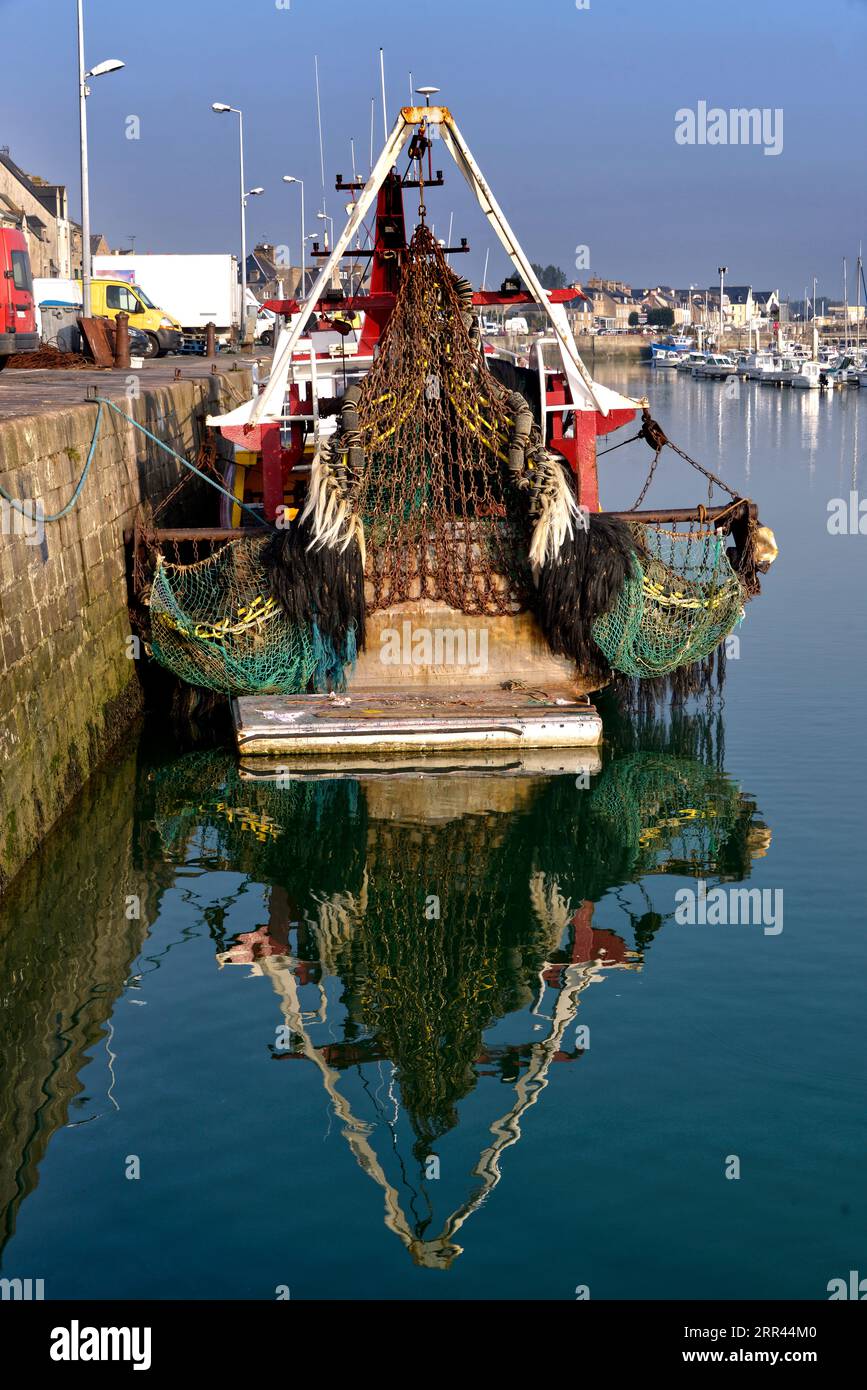 Normandy, France. Colorful fishing net drying on pier after fishermen back  with fresh catch; mooring boats and Saint-Vaast-la-Hougue houses at backgro  Stock Photo - Alamy