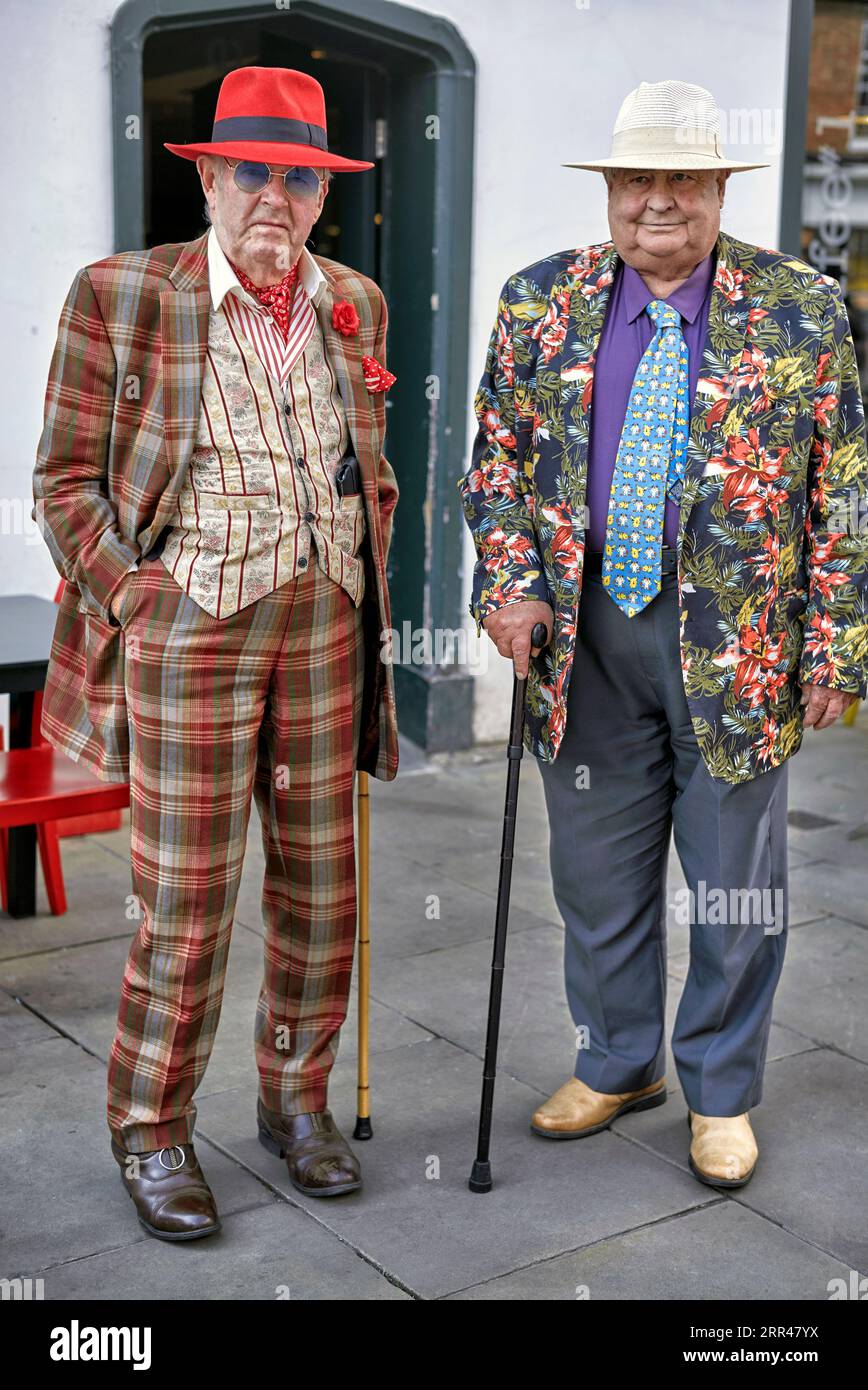 English eccentric seniors dressed in colourful clothes on a day out in town. England UK Stock Photo