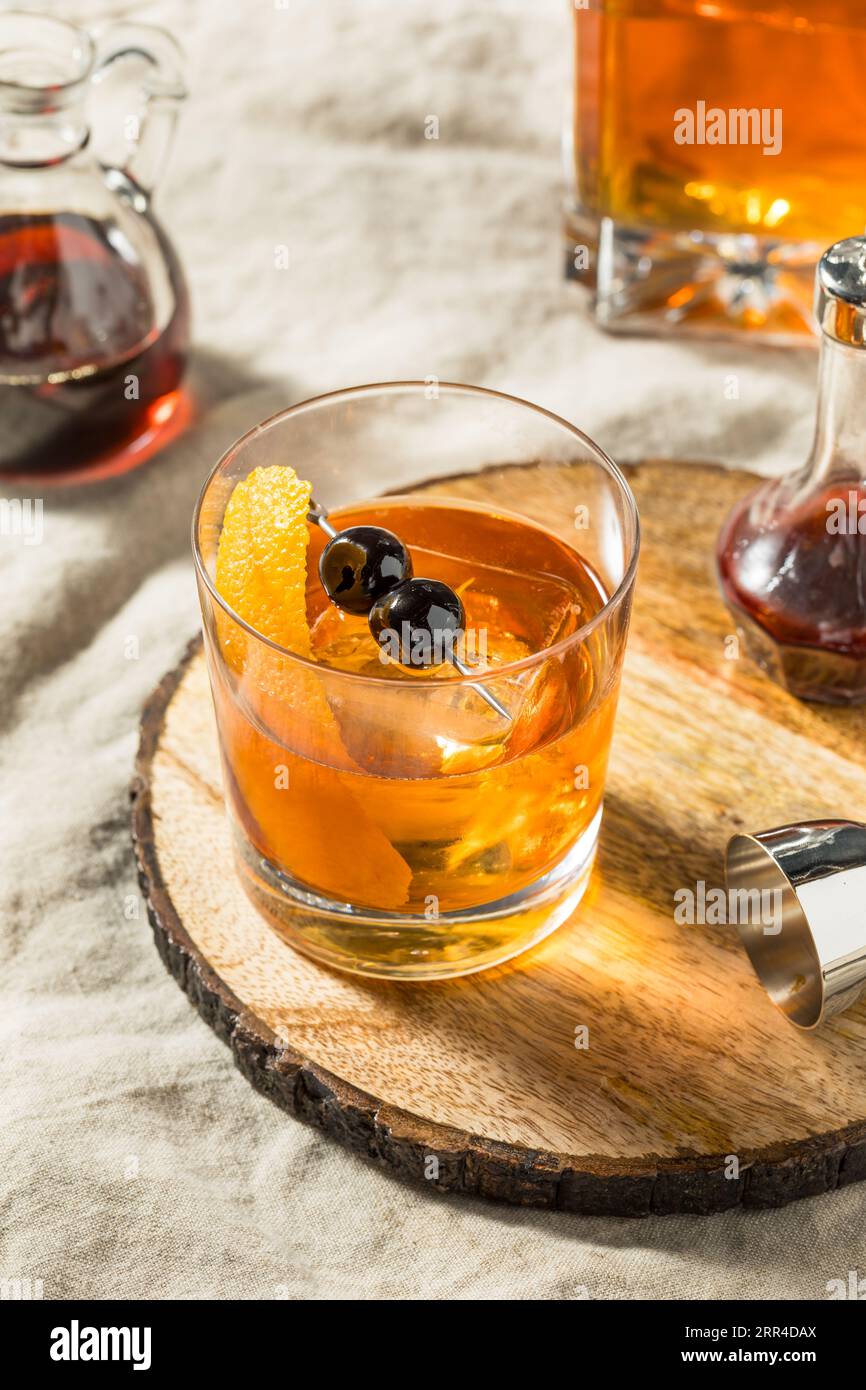 Boozy Maple Syrup Old Fashioned Cocktail with Bourbon and Cherries Stock Photo