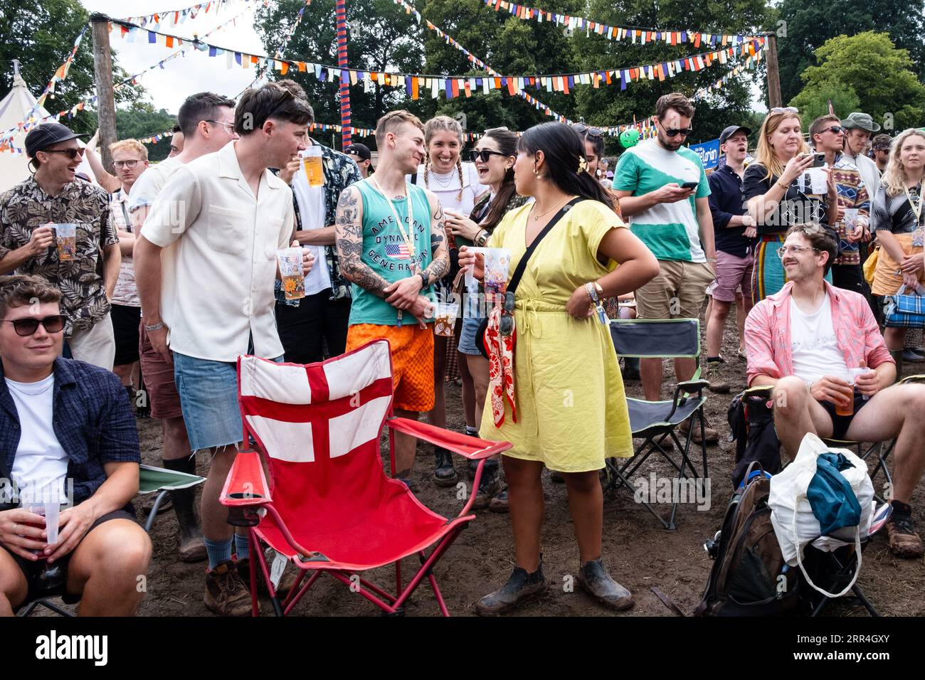 A group of young friends with beers in the Walled Garden area at Green