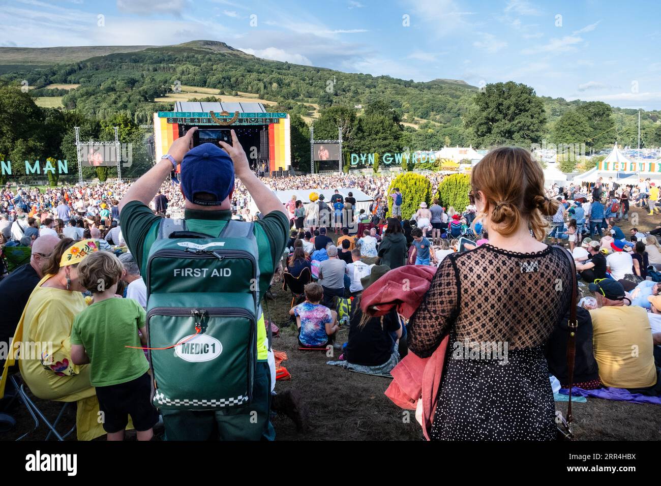 A First Aid volunteer takes a picture at the main Mountain Stage at