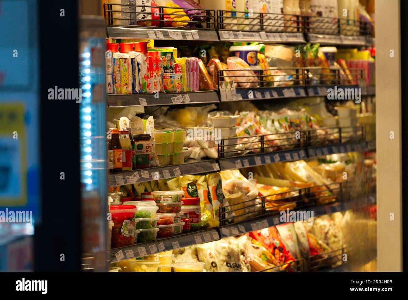Supermarket ready meals and packaged food items sit on shelves at a