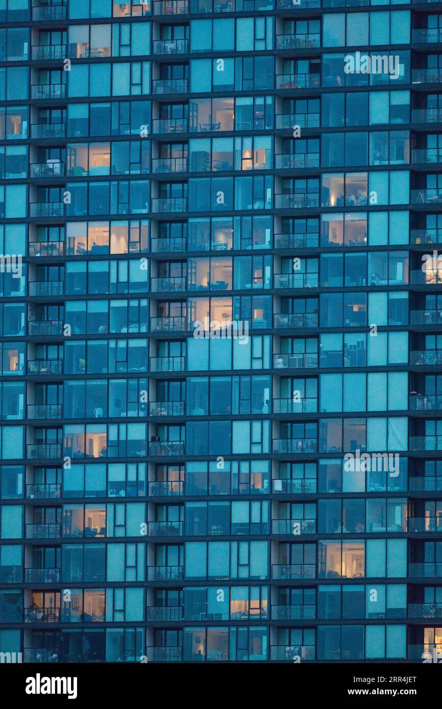 Apartment building exterior view showing blue tinted glass windows and balconies, Melbourne, Australia. Stock Photo